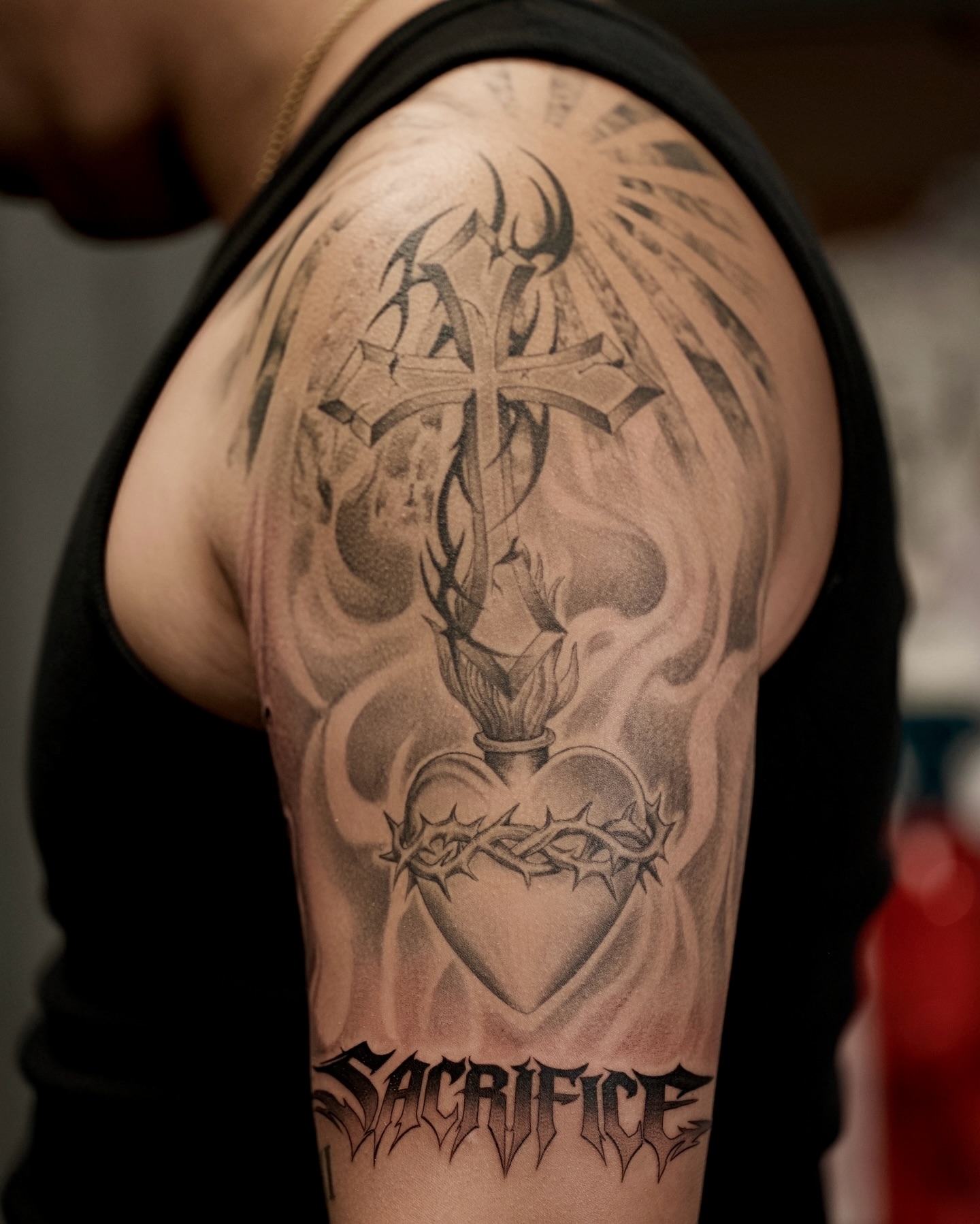 Heart with cross realism tattoo on the upper arm by Damon_modoink