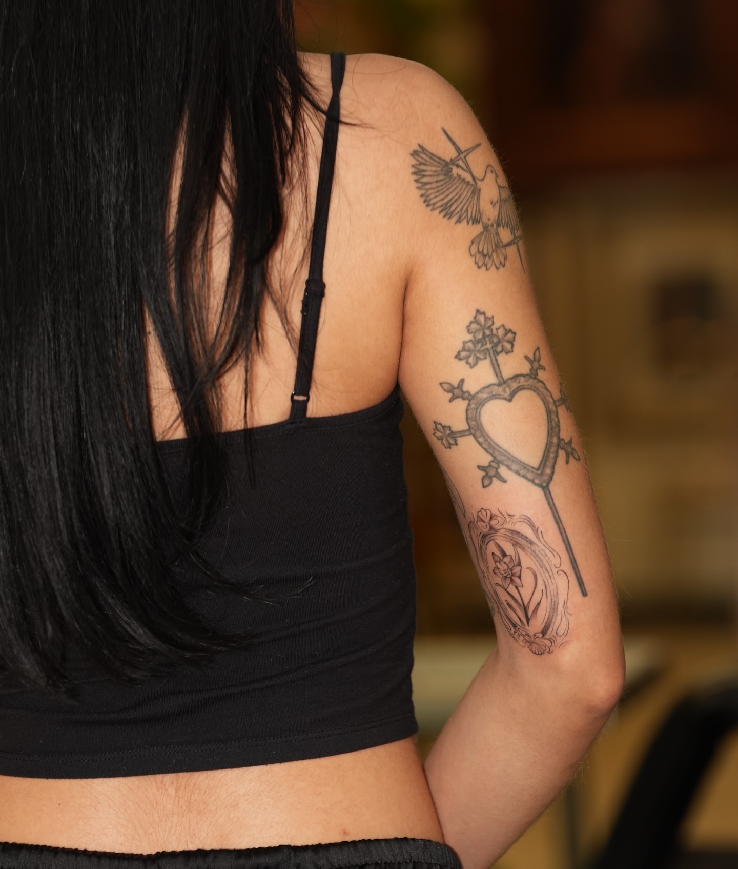 Heart with cross black and grey tattoo on the upper arm by Kevin Betancourt