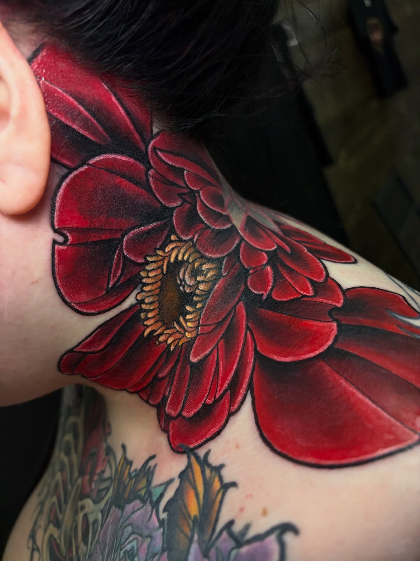 Red flower realism tattoo on the shoulder by BodyArtByAlia