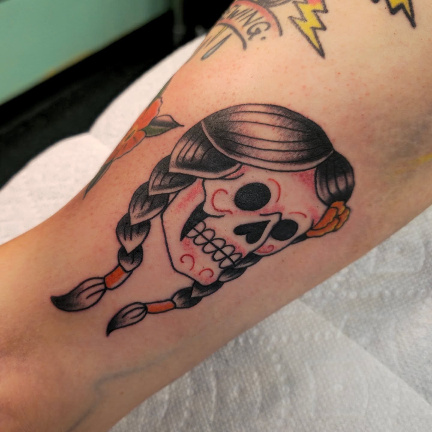 Skull with braids American traditional tattoo on the forearm by Tattoo Artist, Orange, California