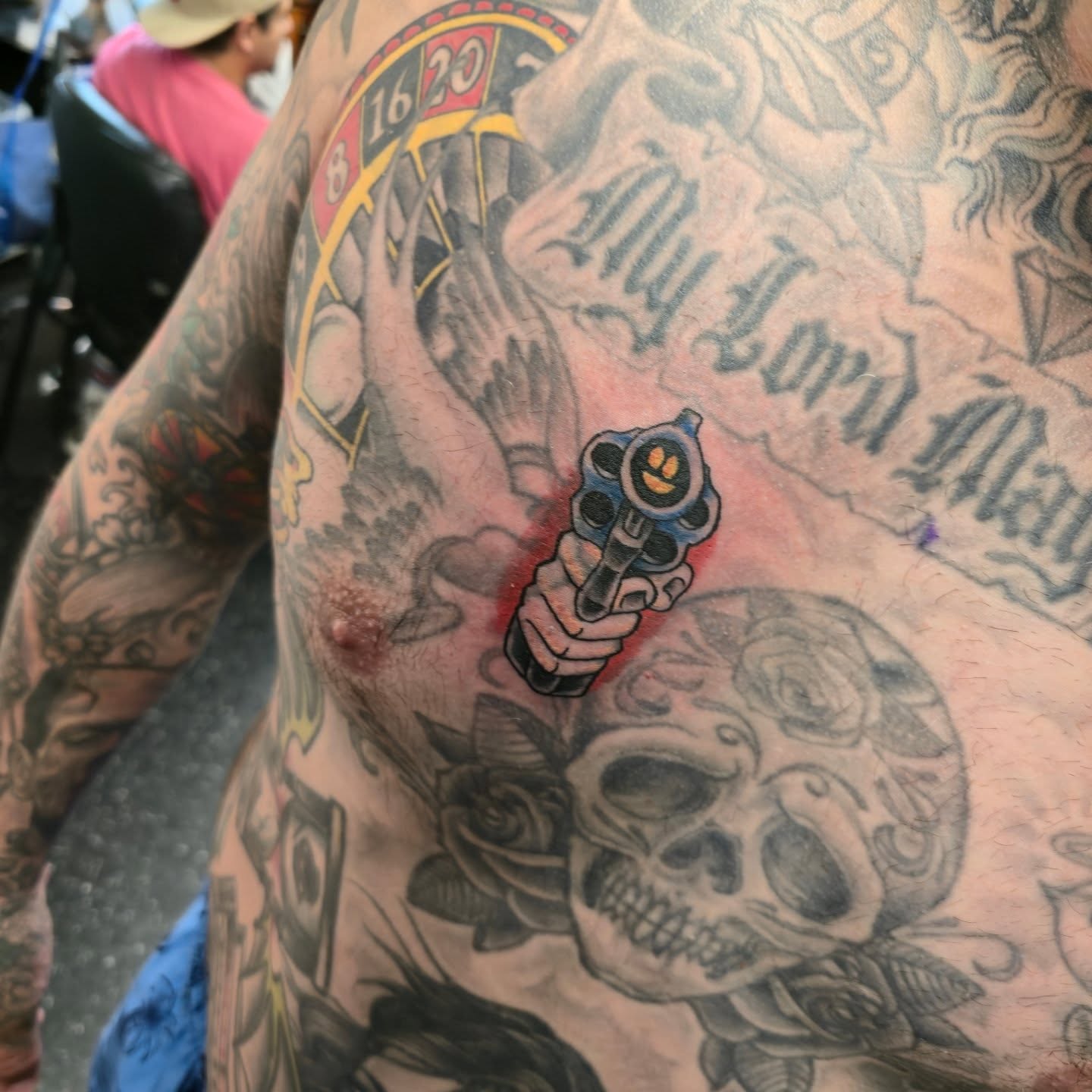 Gun and skull American traditional tattoo on the chest by Tattoo Artist, Orange, California
