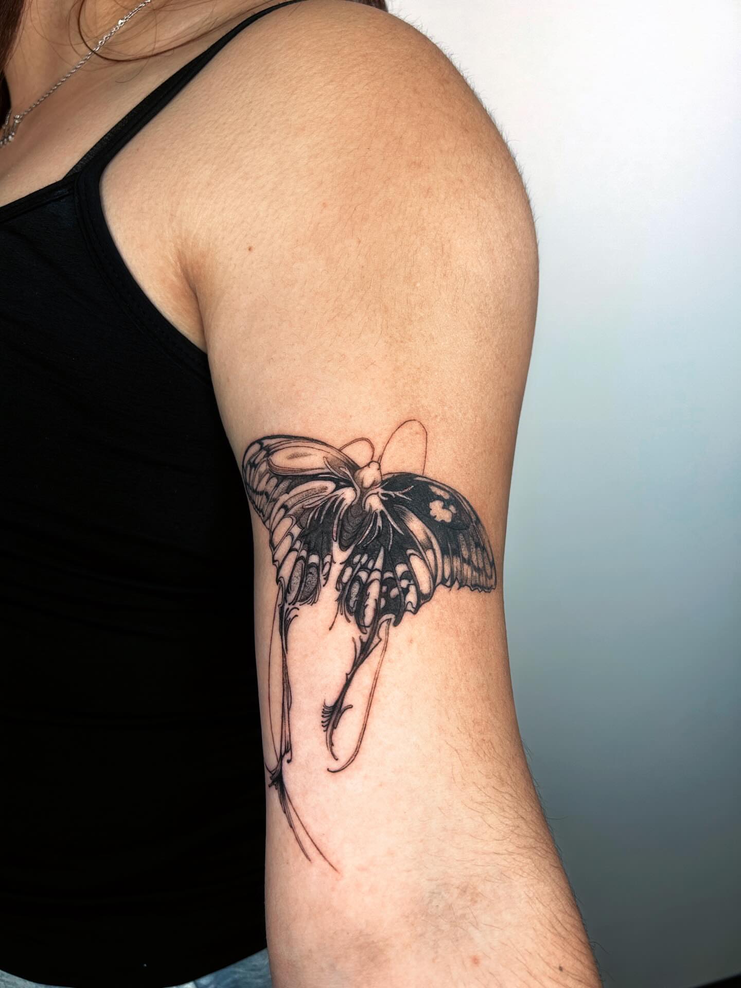 Butterfly black and grey tattoo on the forearm by J