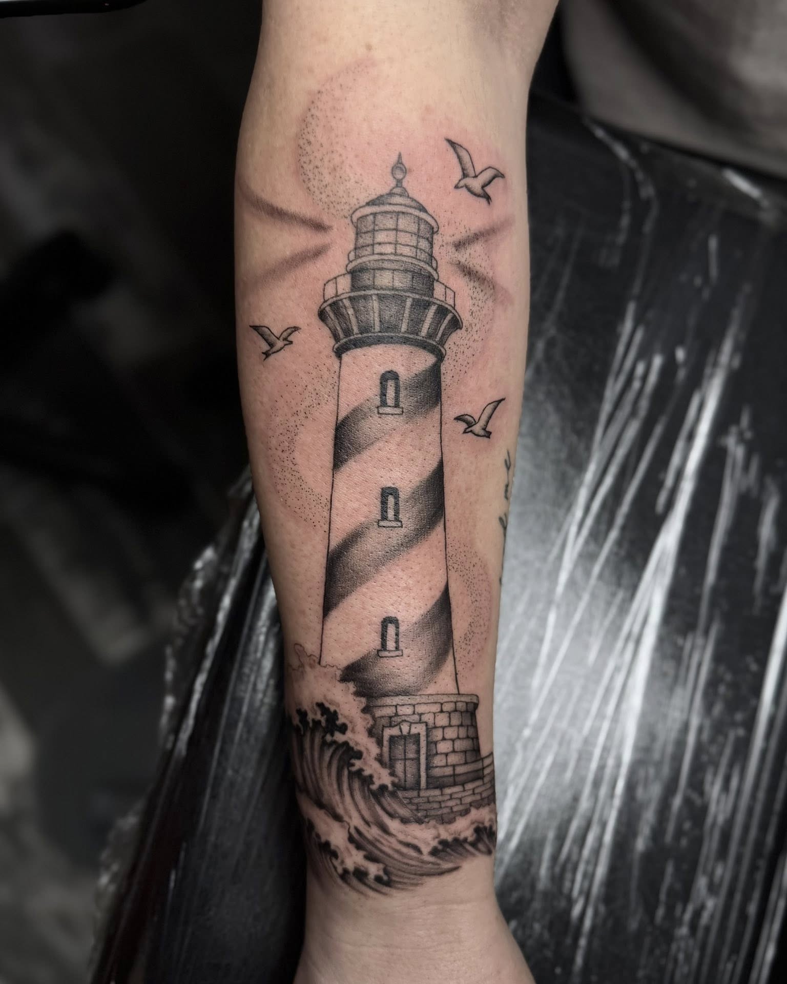 Lighthouse dotwork tattoo on the forearm by Madison Jasso