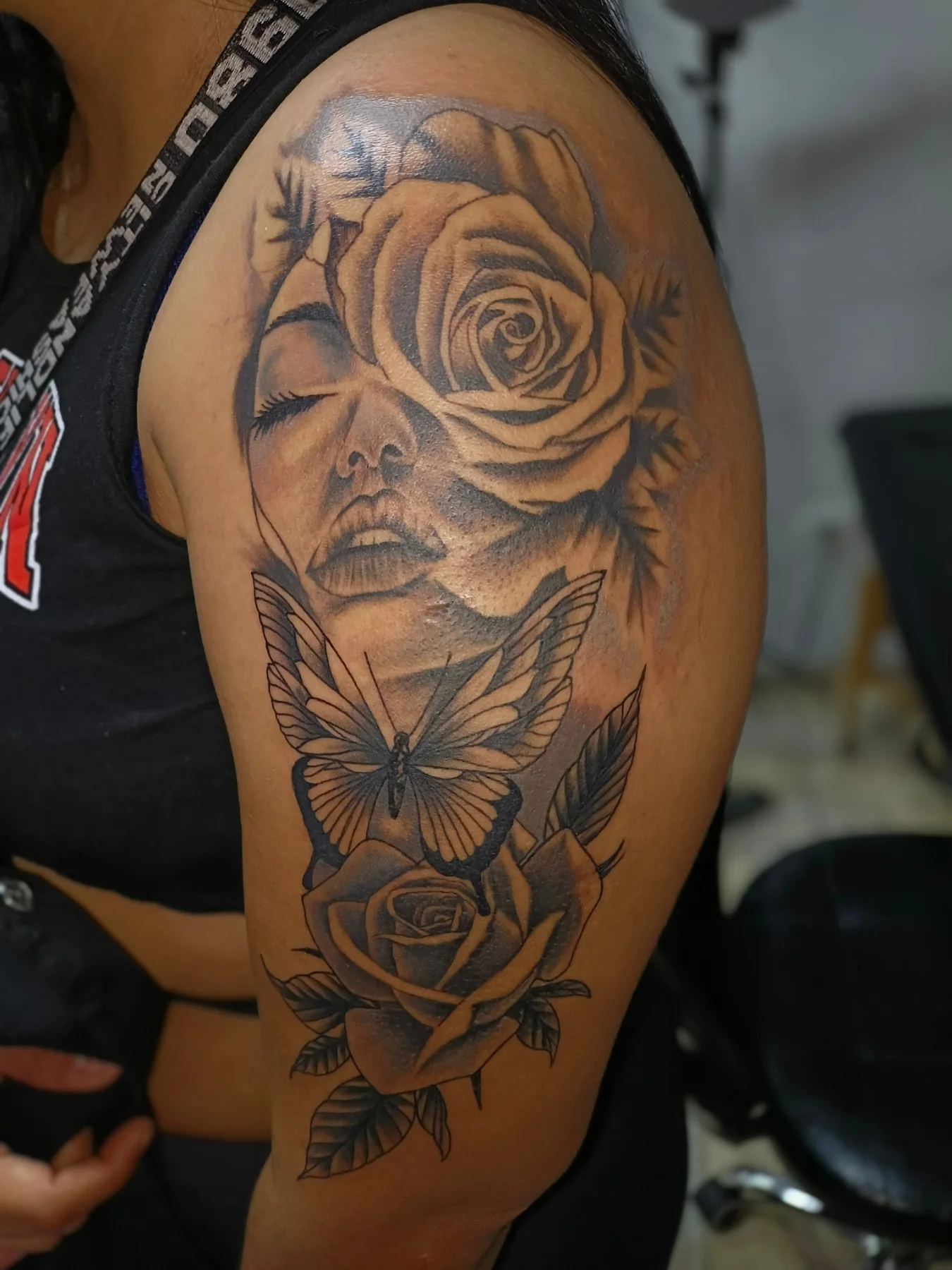 Woman with roses realism tattoo on the shoulder by Alexander Tattooink
