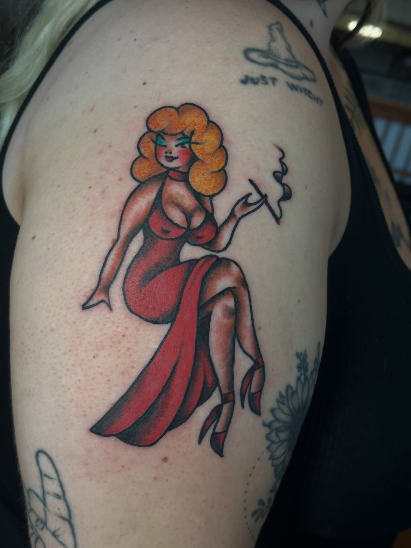 Pin-up girl American traditional tattoo on the shoulder by Providence Tattooer
