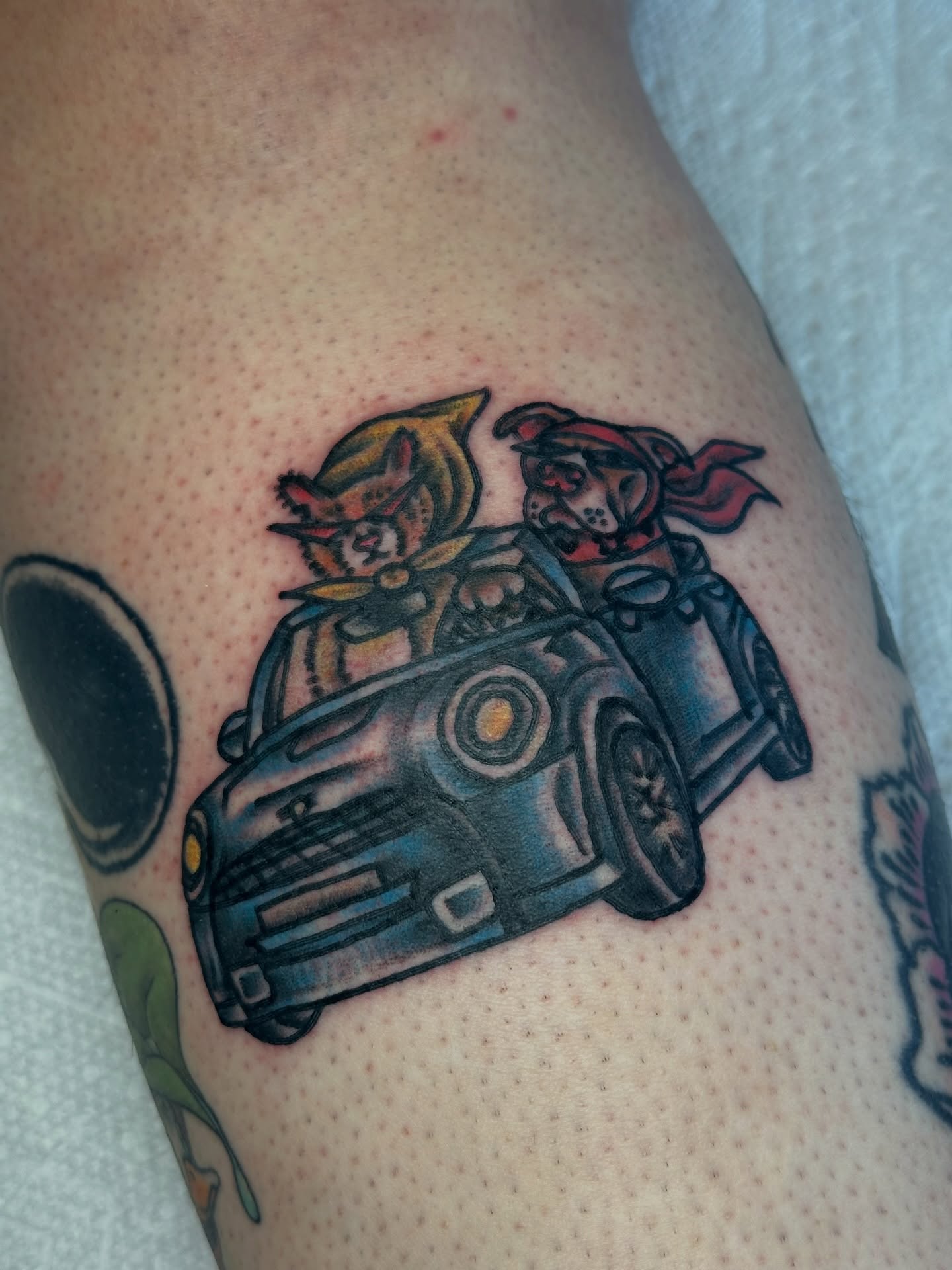 Car with characters American traditional tattoo on the thigh by Providence Tattooer