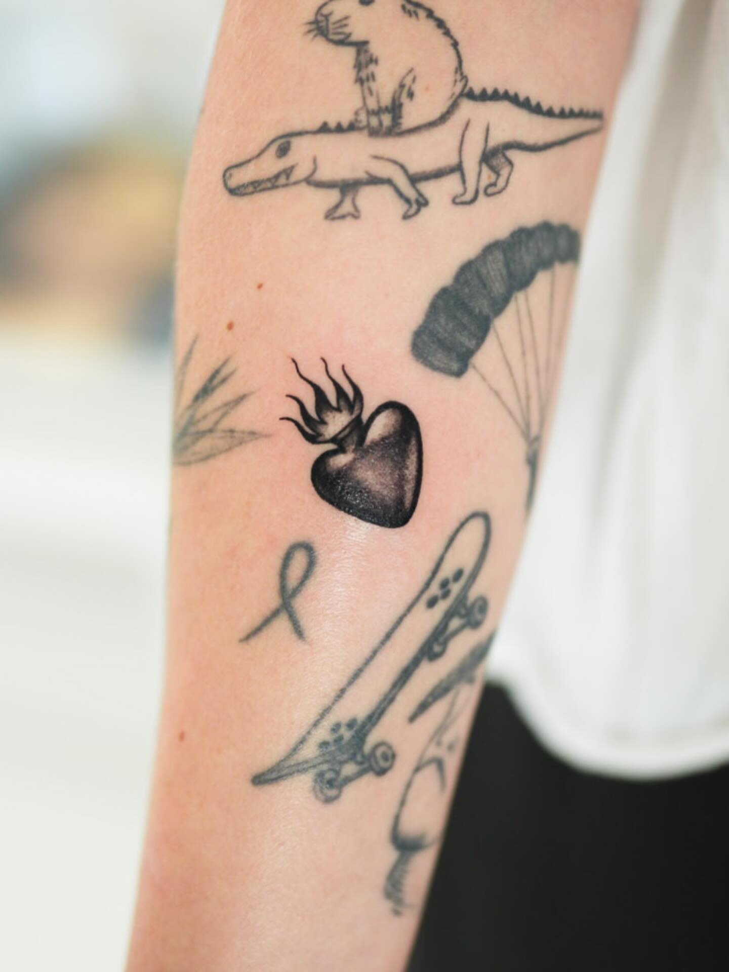 Heart with flame black and grey tattoo on the forearm by ππππππ