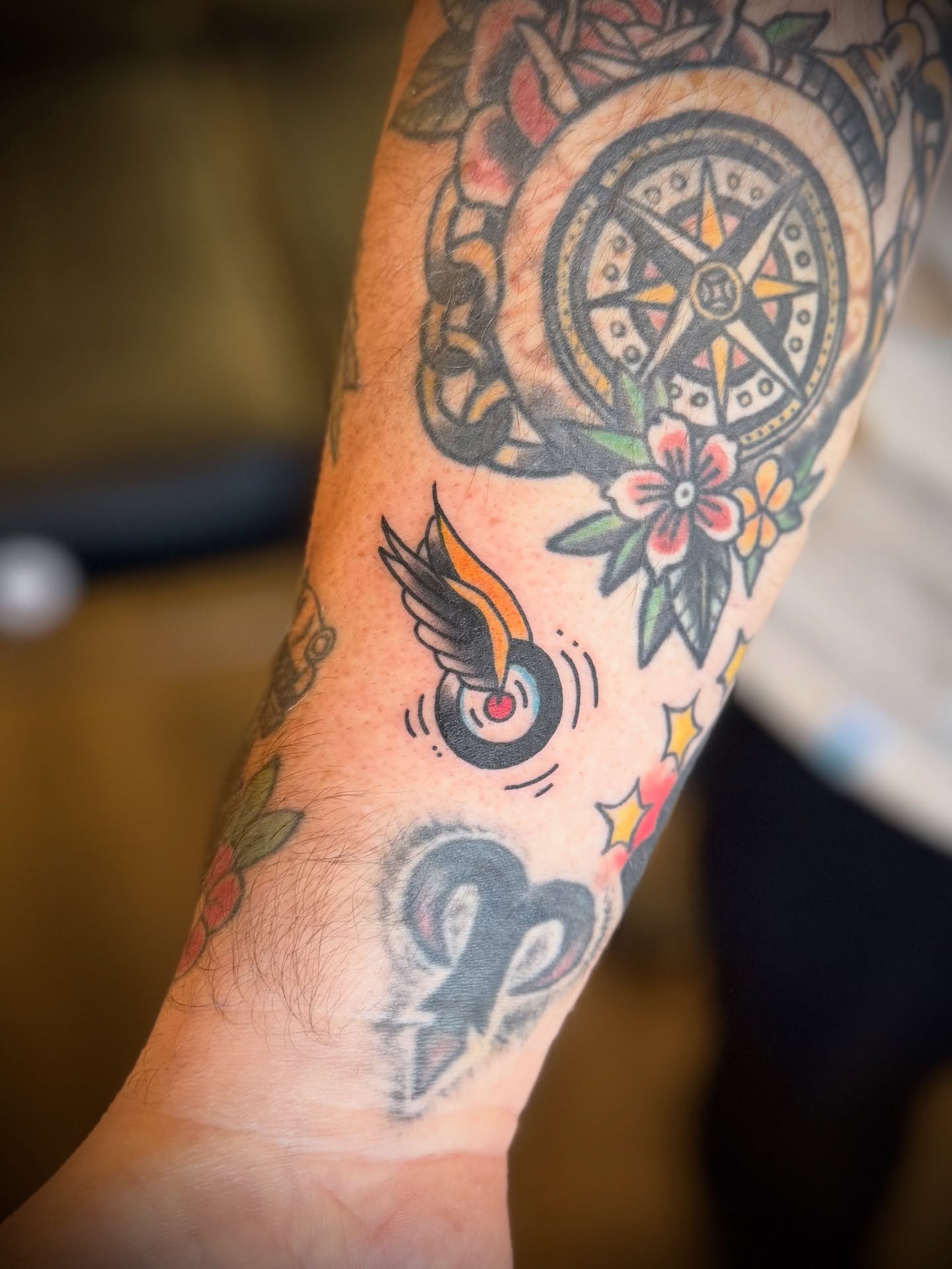 Compass and floral American traditional tattoo on the forearm by Justin Bianchini - New Orleans Tattoo Artist