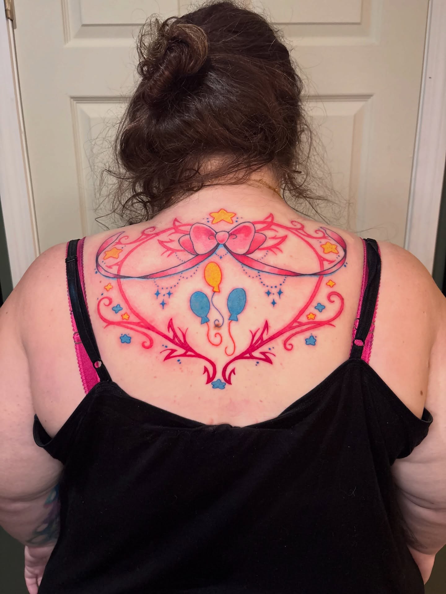 Balloons and bow new school tattoo on the back by Callum