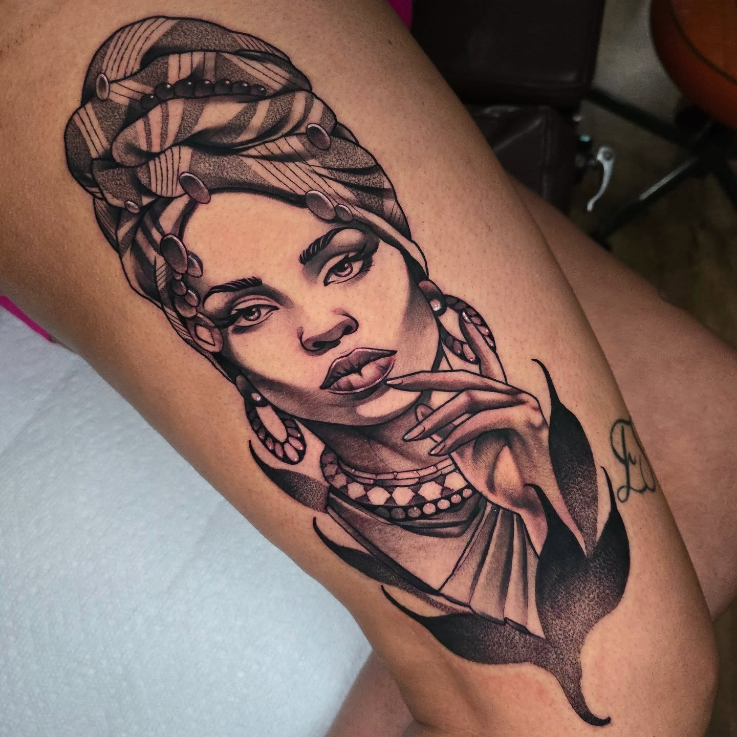 Woman with turban realism tattoo on the thigh by Justin Eldridge