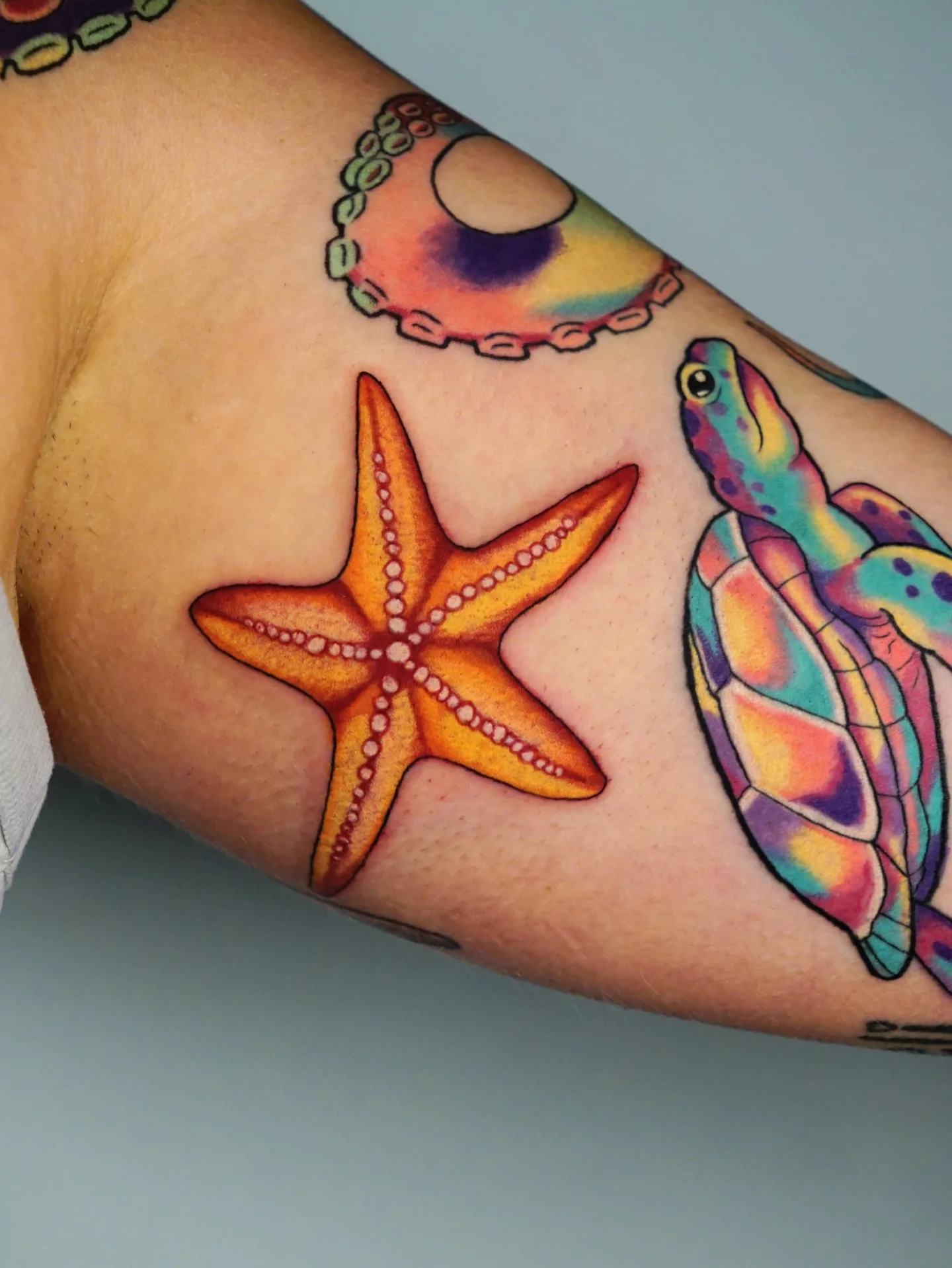 Starfish and turtle new school tattoo on the forearm by kylie, San Antonio, Texas