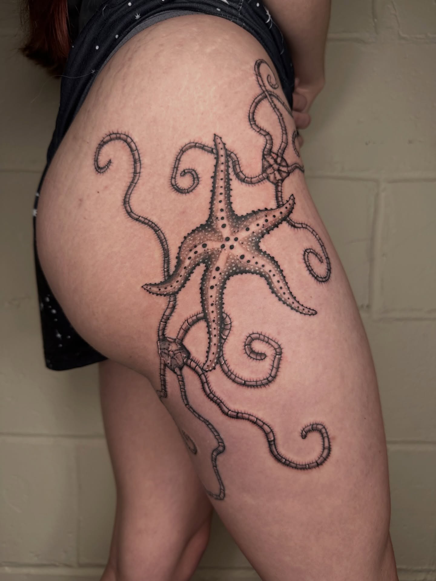 Octopus dotwork tattoo on the thigh by father