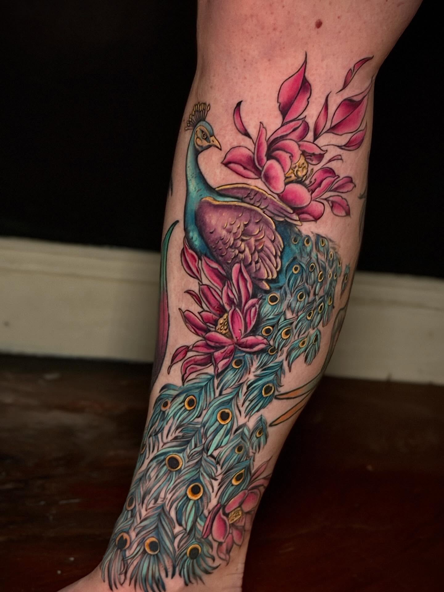 Peacock and flowers new school tattoo on the forearm by Giovanna Kline