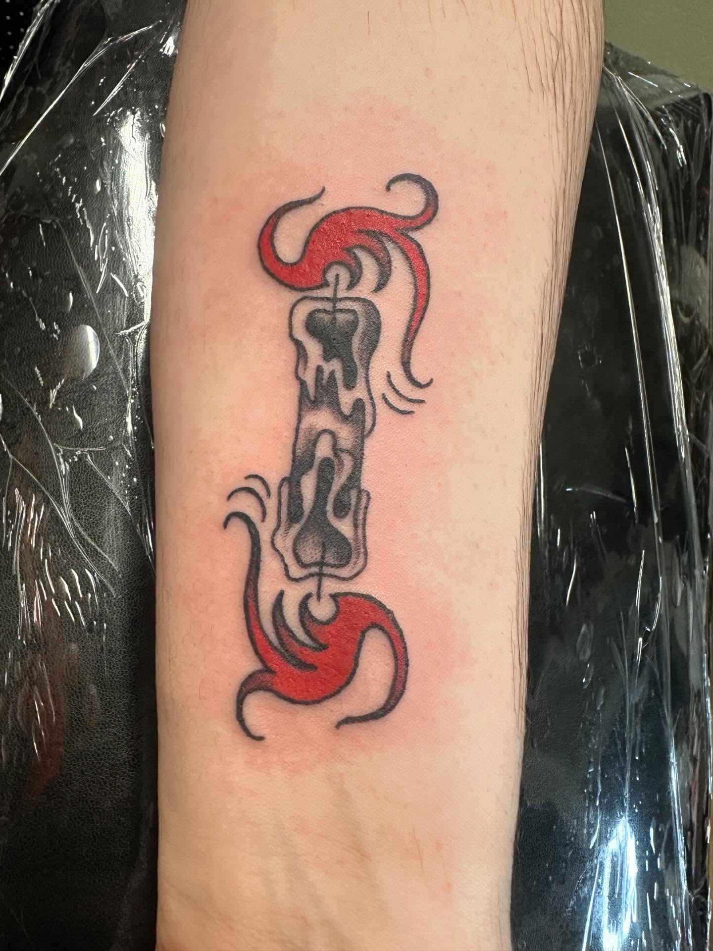 Burning candle dotwork tattoo on the forearm by Kaylee Woods