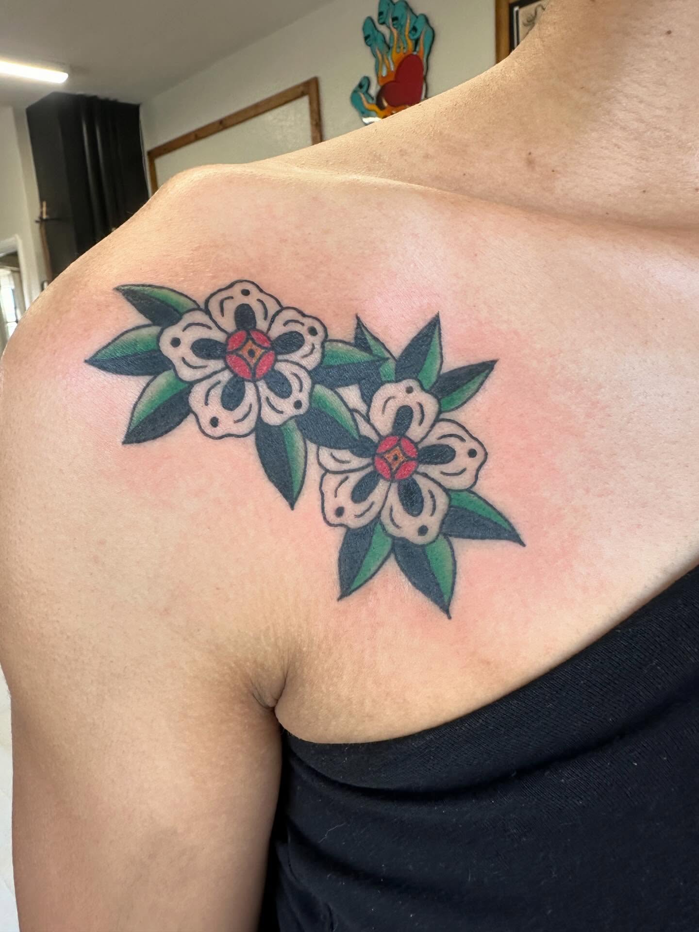 Flowers American traditional tattoo on the shoulder by Kaylee Woods