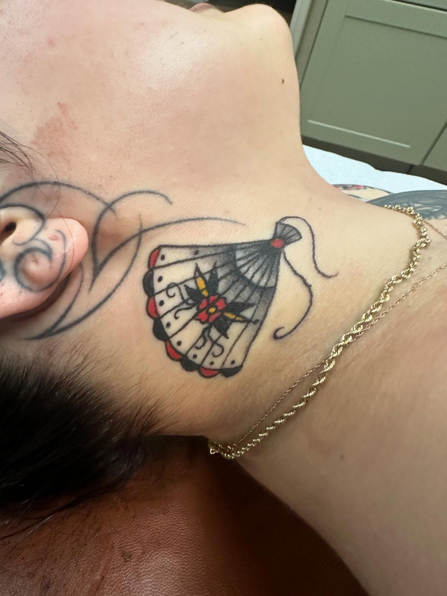 Butterfly American traditional tattoo on the neck by Kaylee Woods