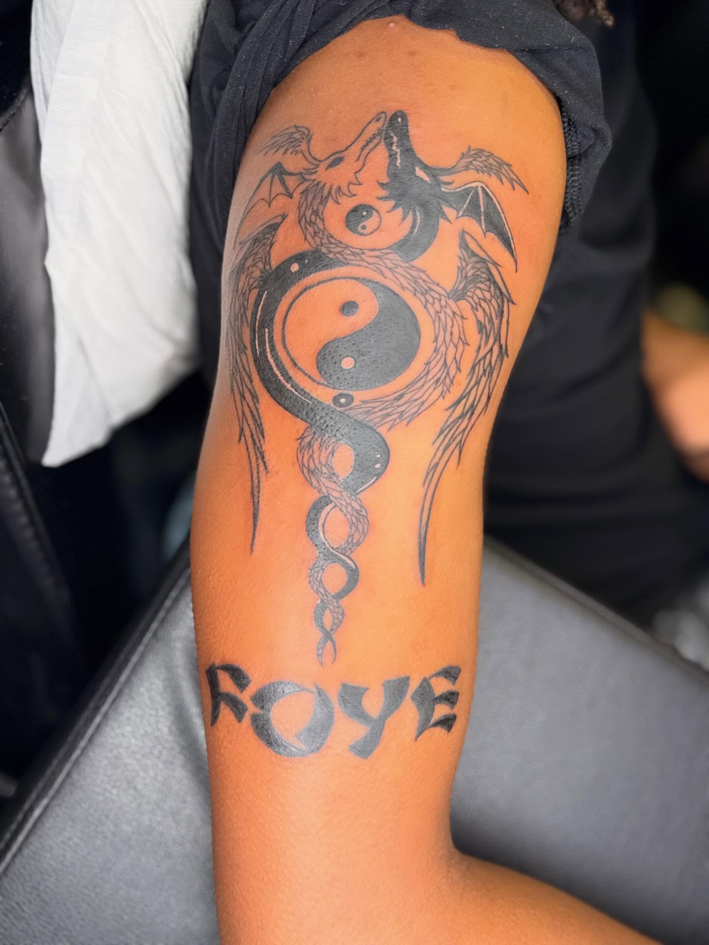 Yin yang dragon geometric tattoo on the forearm by Jazz Walker