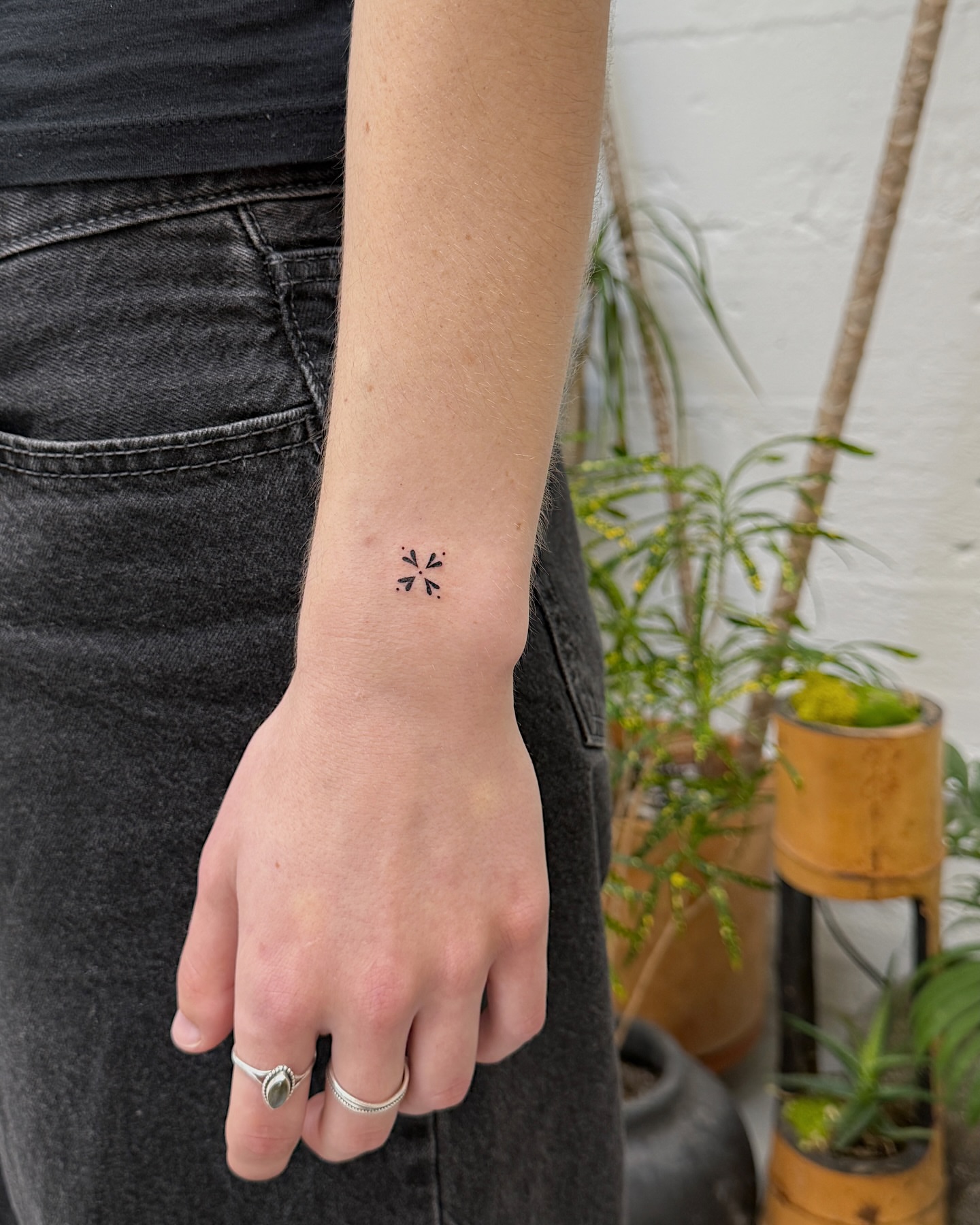 Geometric symbol minimalist tattoo on the forearm by Inky Apricot, Austin, Texas