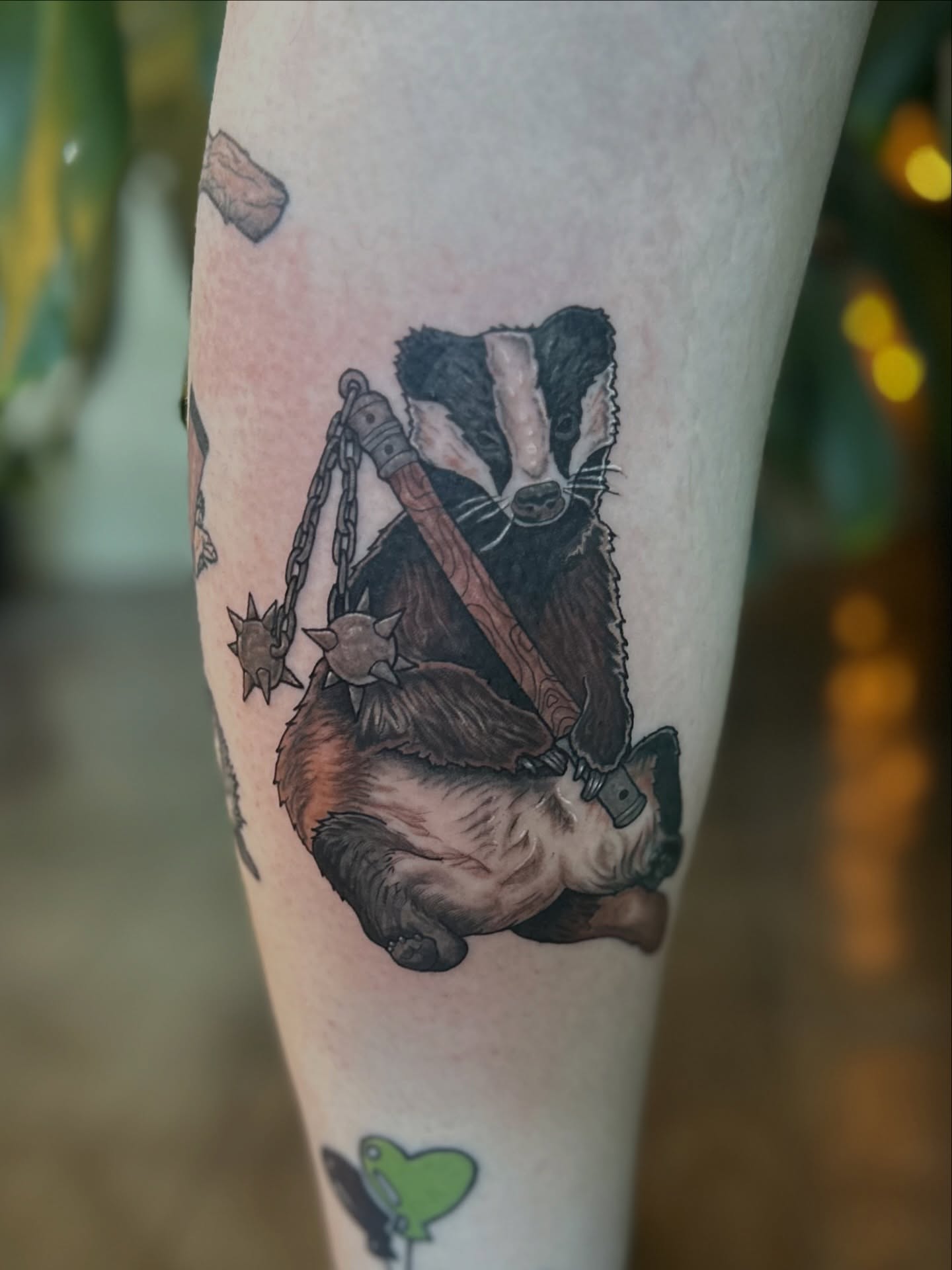 Badger with weapon realism tattoo on the forearm by Ransom