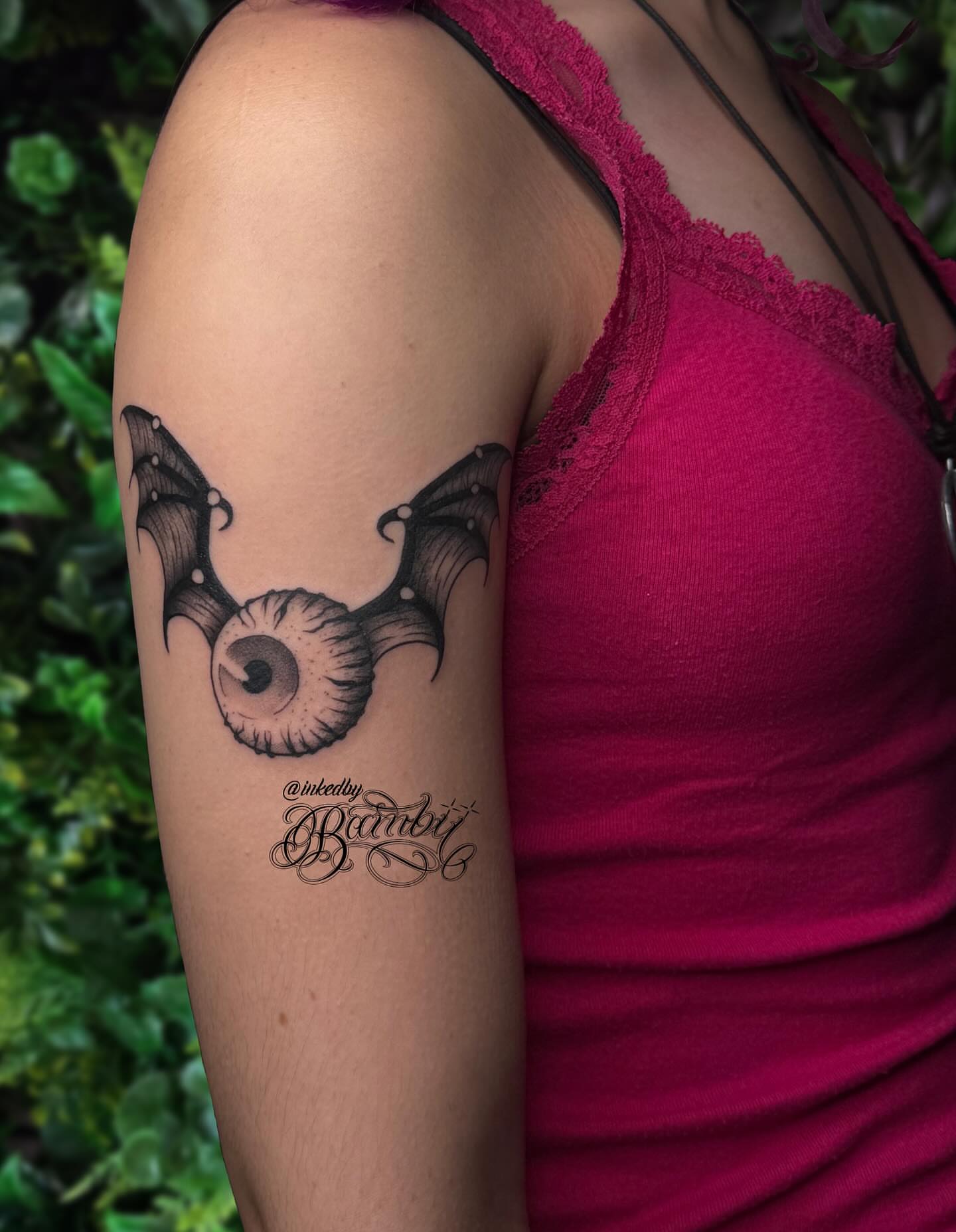 Bat wings and eye black and grey tattoo on the forearm by Ember