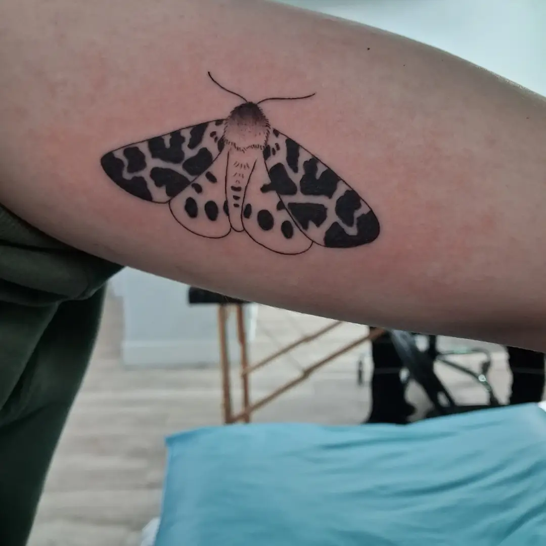 Moth realism tattoo on the forearm by James Ostler