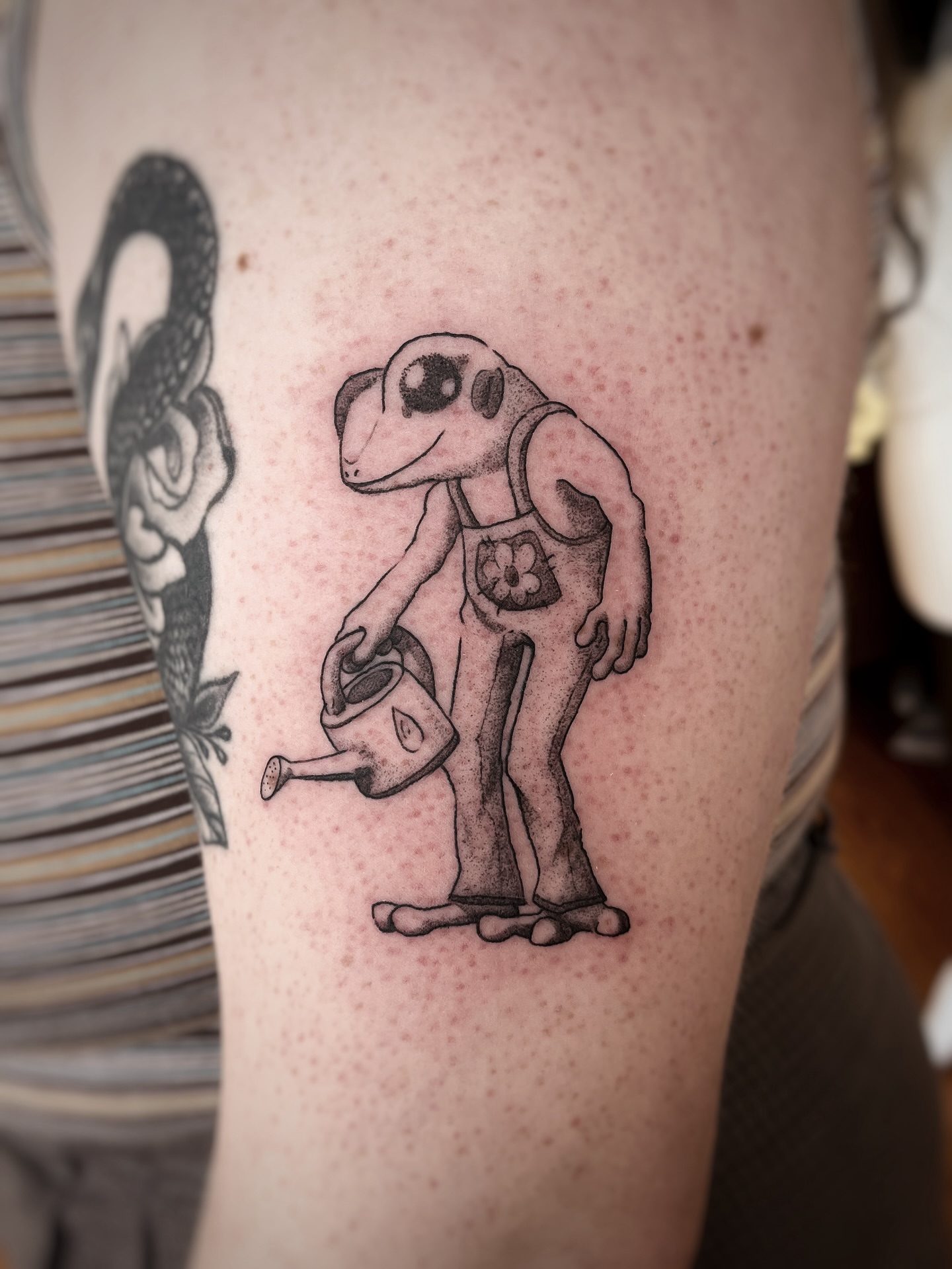 Robot watering can black and grey tattoo on the forearm by Risa Cincinnati Tattoo Artist