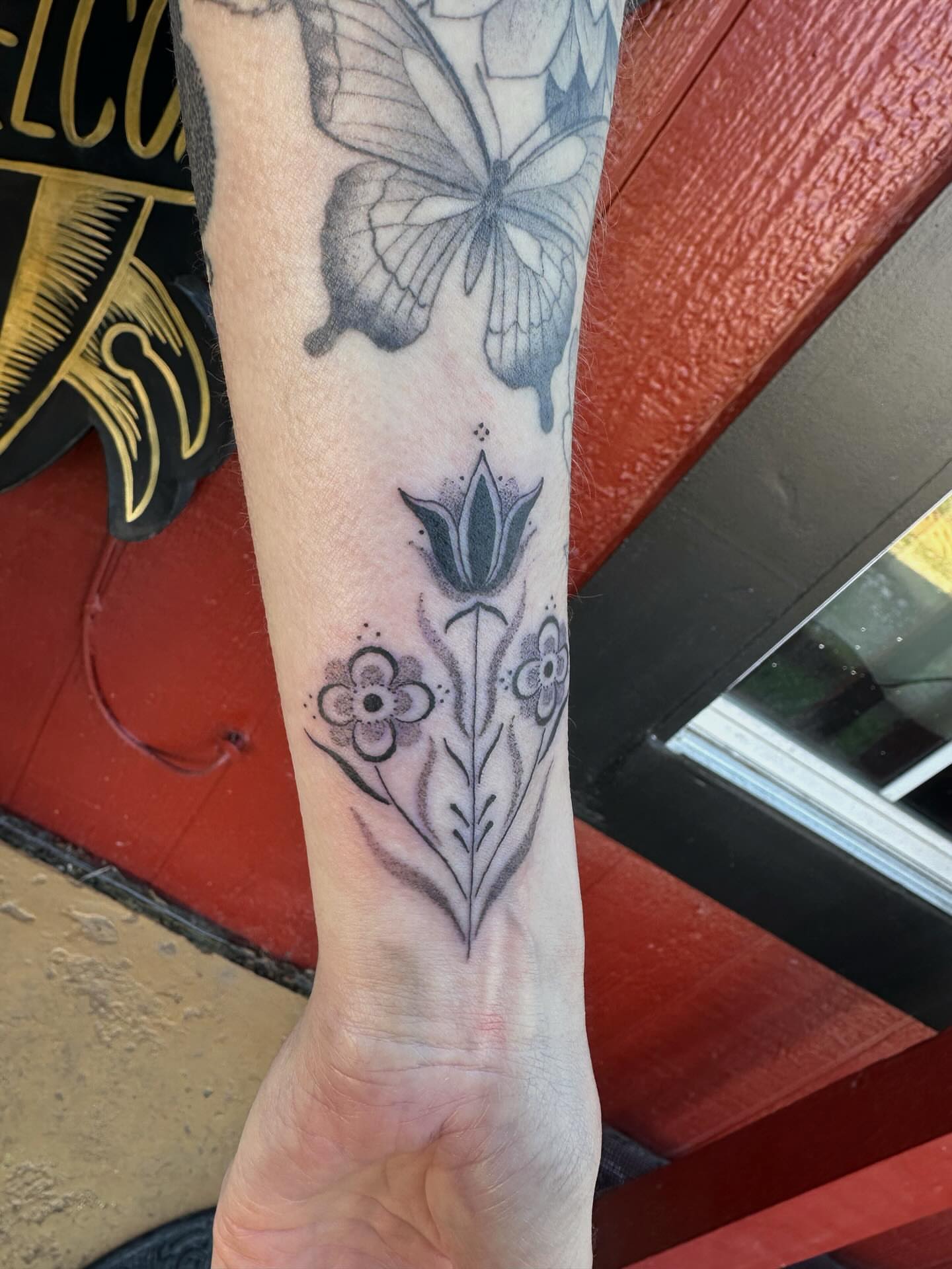 Floral design black and grey tattoo on the forearm by J Valentin