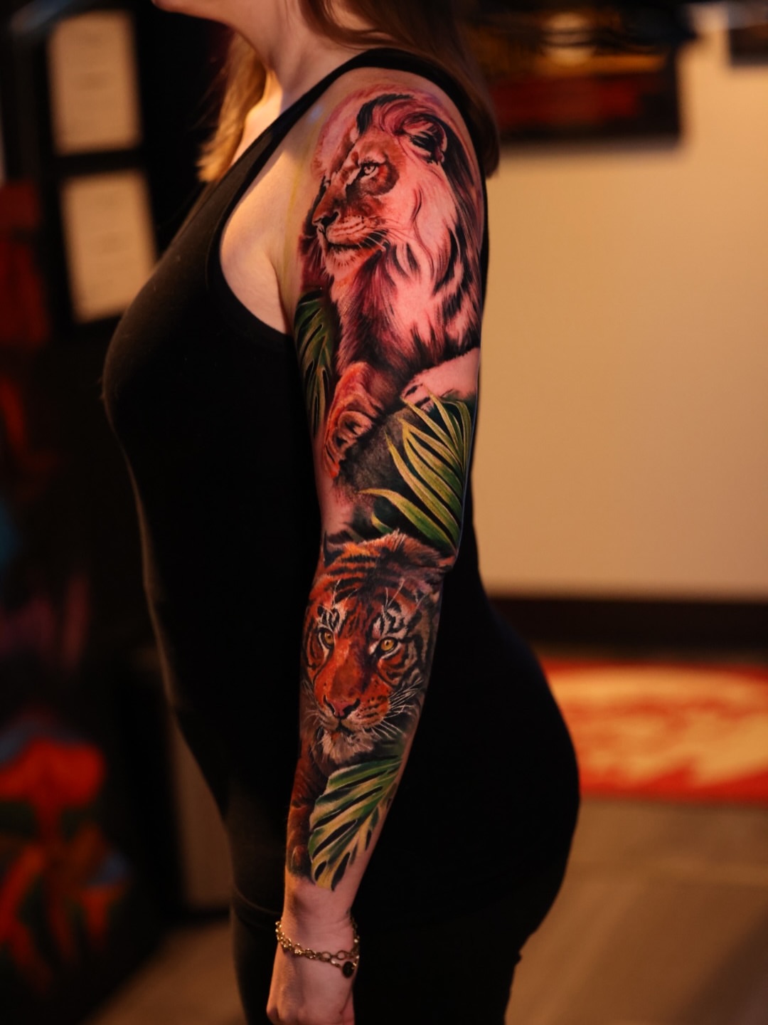 Lion and tiger realism tattoo on the upper arm by Brandon Sontag
