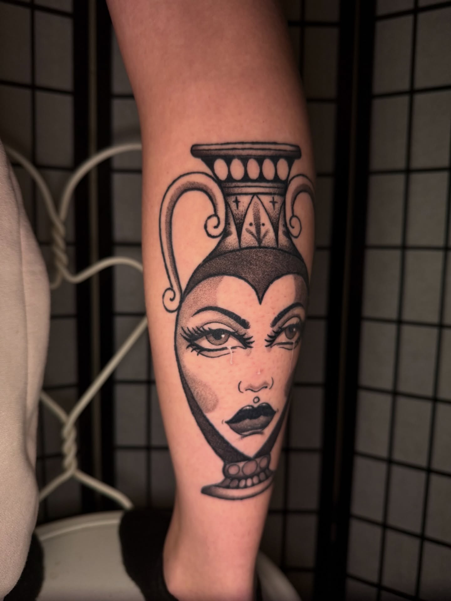 Woman's face with vase realism tattoo on the forearm by Austin Poliszuk, Minneapolis, Minnesota