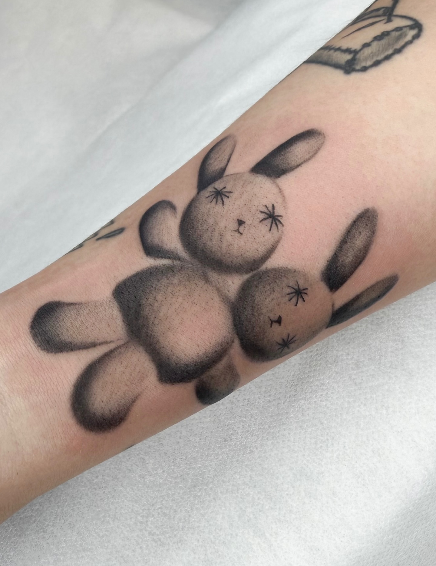 Bunny black and grey tattoo on the forearm by Red