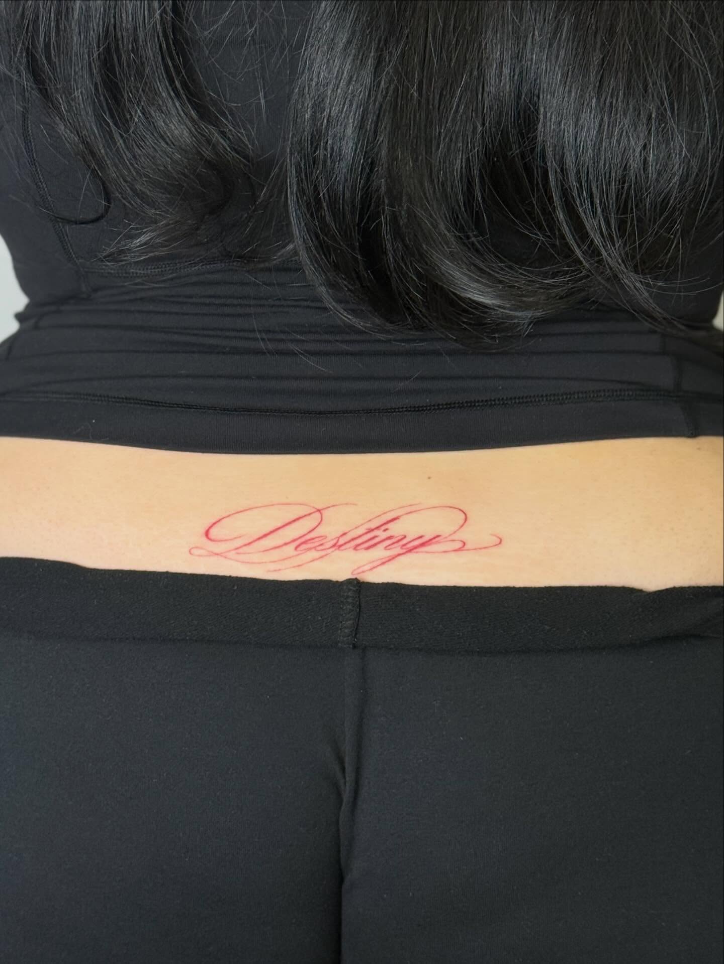 Destiny lettering script tattoo on the upper arm by Nevaeh tattoo artist