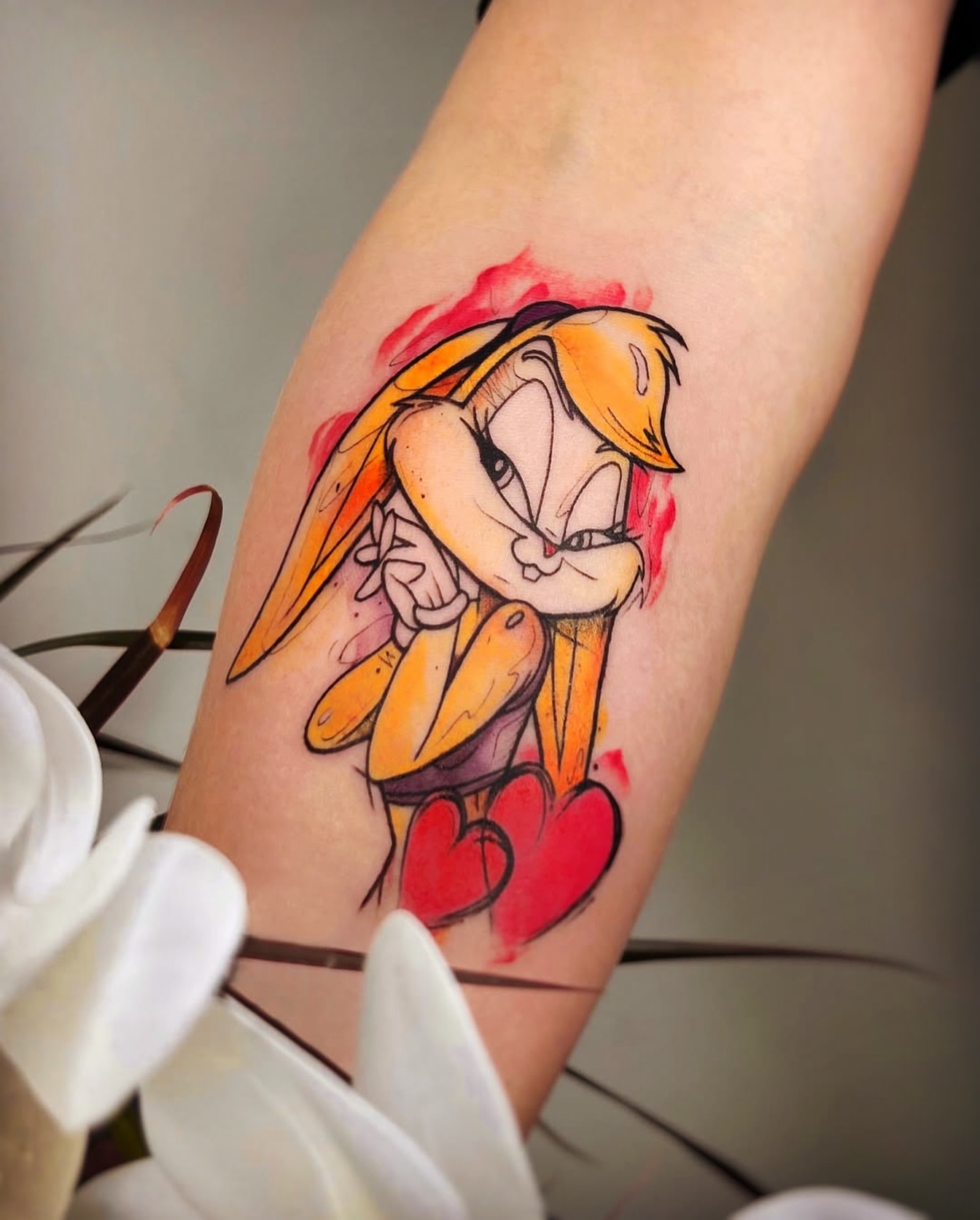 Looney tunes character watercolor tattoo on the forearm by Nina Fedorchenko