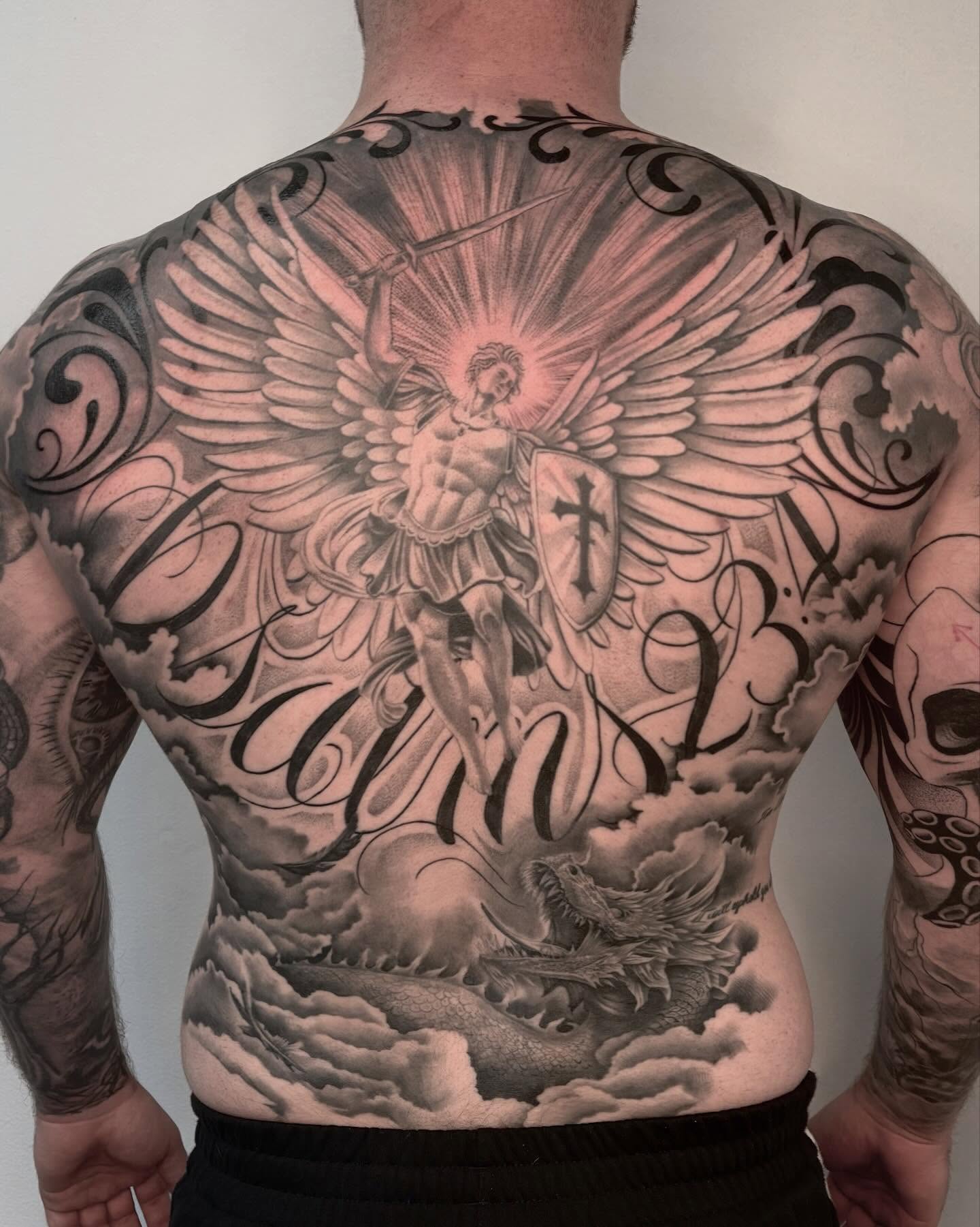 St. michael slaying dragon realism tattoo on the back by Avery Mullins
