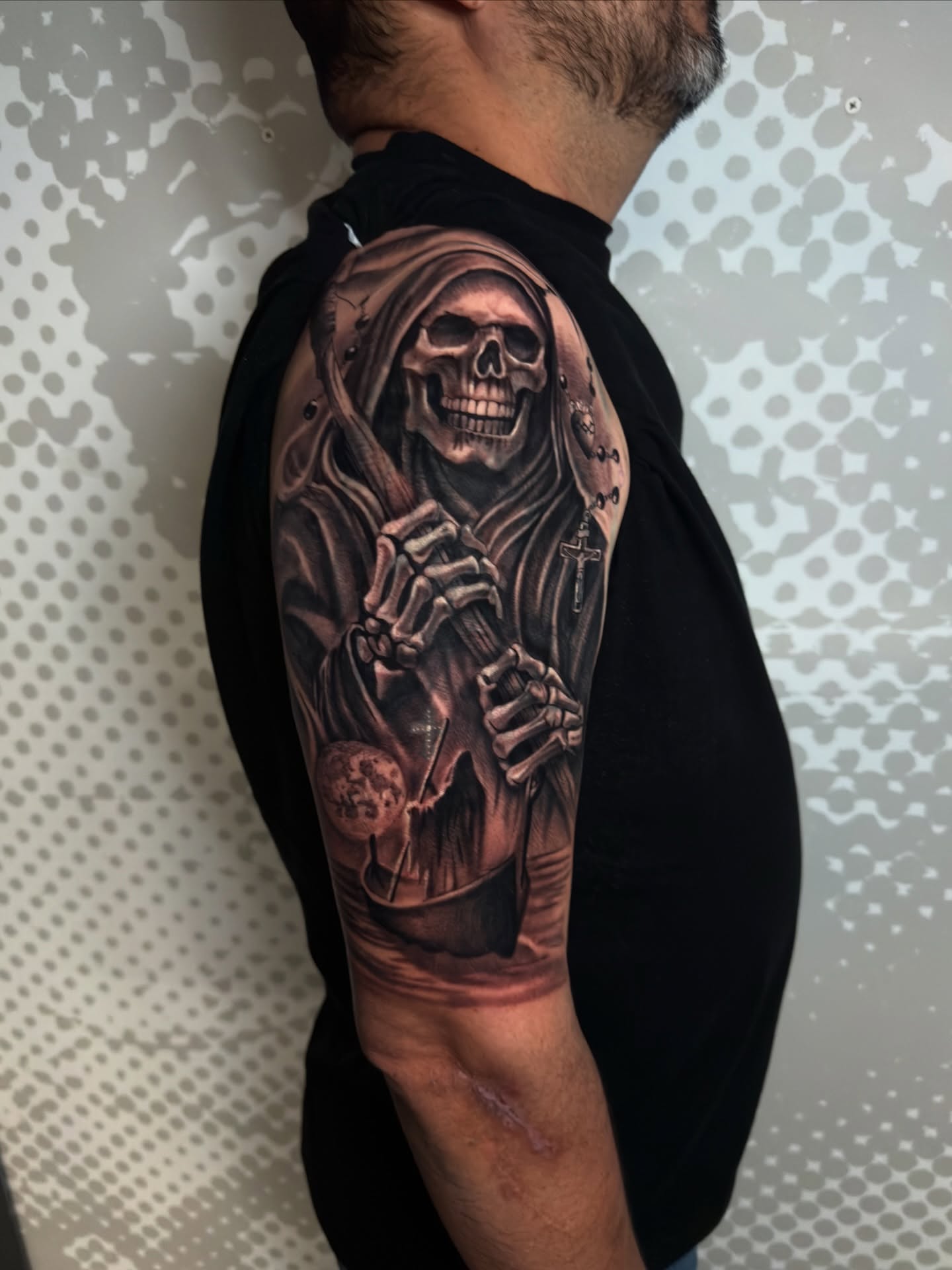 Reaper realism tattoo on the upper arm by Charlotte Tattoo Artist
