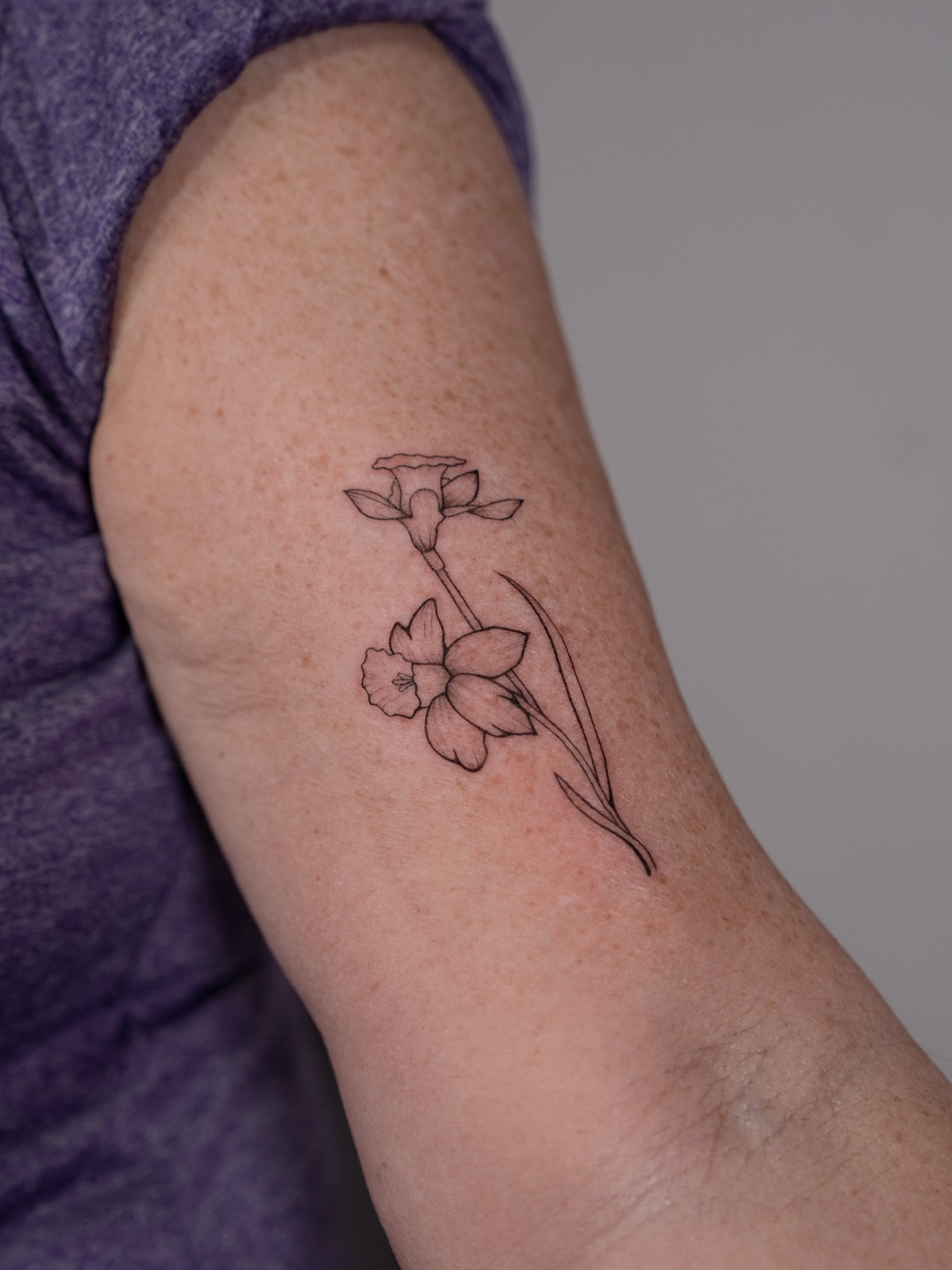 Daffodil fine line tattoo on the forearm by Ash - Fineline Tattoo Apprentice