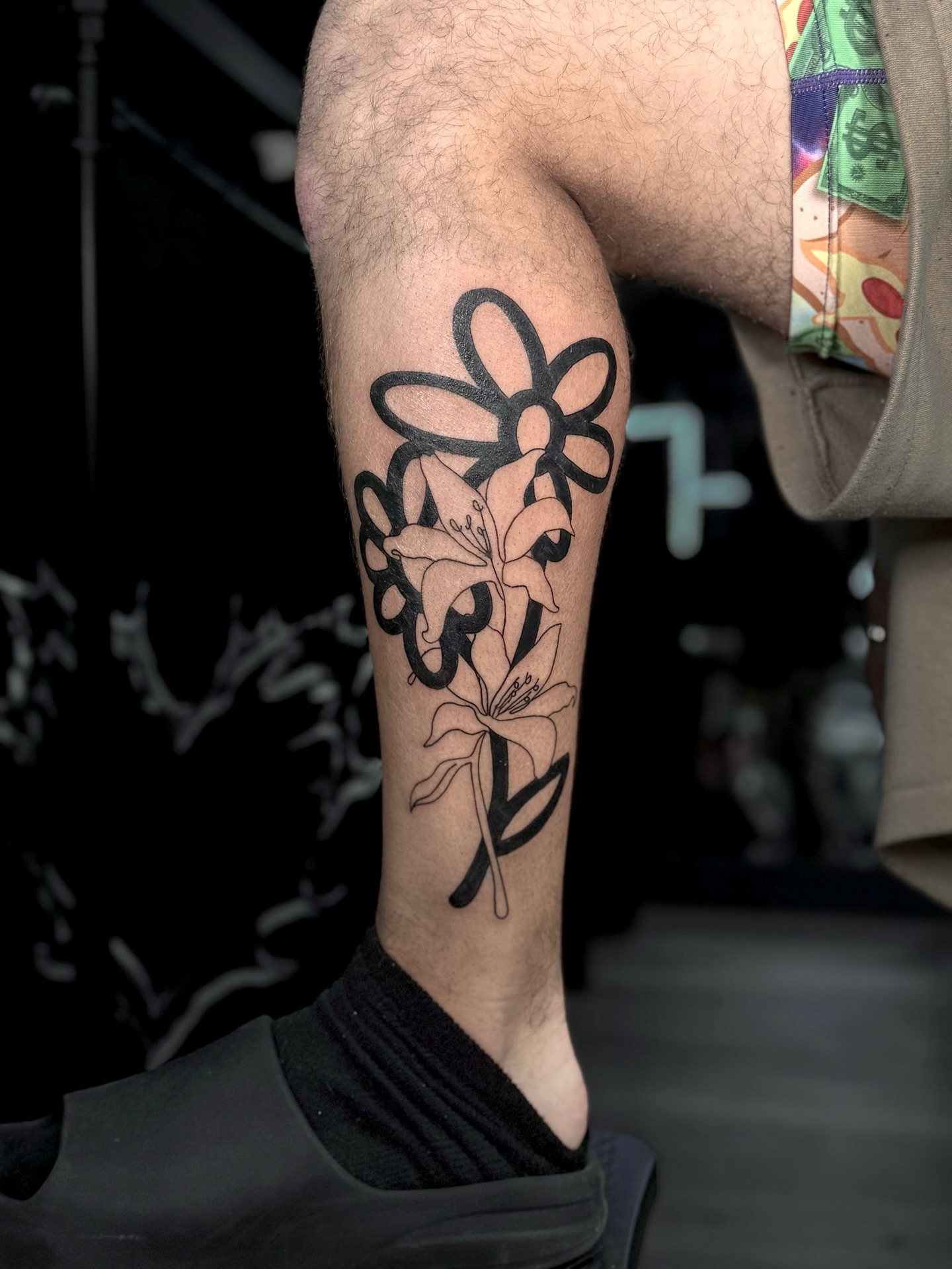 Lily and flower black and grey tattoo on the forearm by Elijah Cosme, Miami, Florida