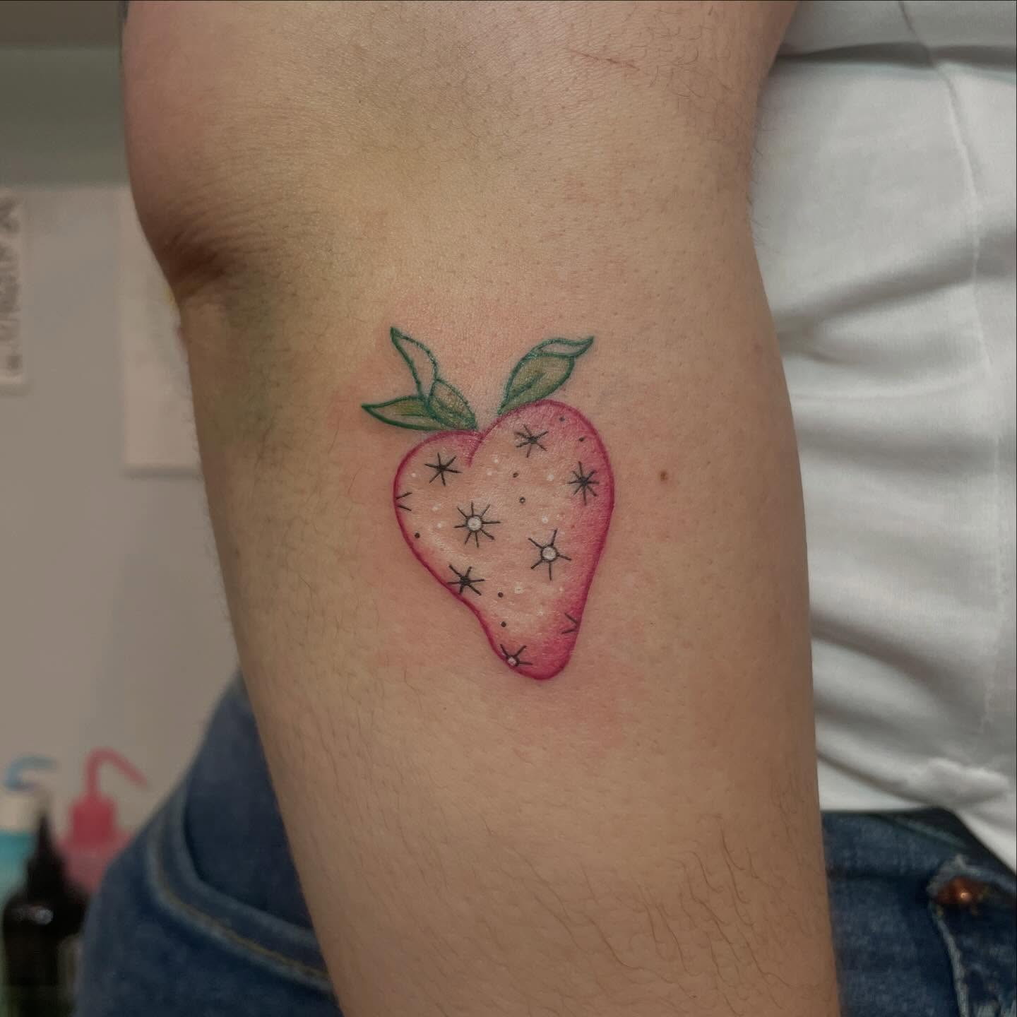 Strawberry dotwork tattoo on the forearm by Ally Easter, Berkeley, California