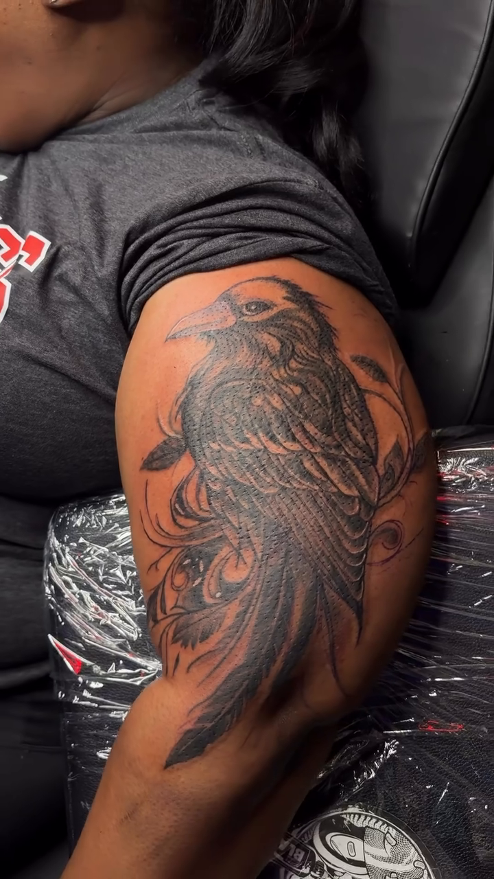 Raven on arm fine line tattoo on the upper arm by DOE๐๐น