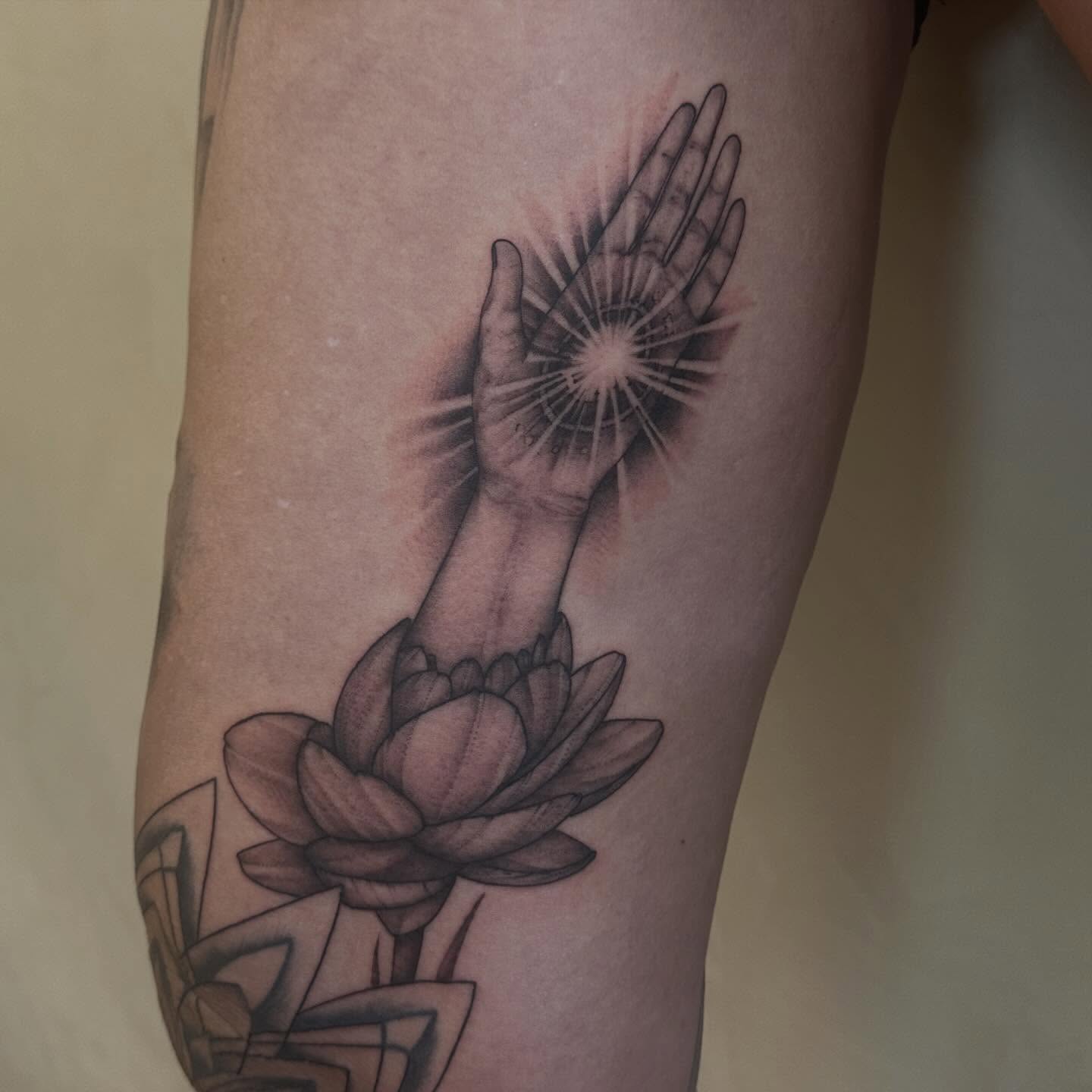 Hands and lotus flower realism tattoo on the forearm by Dallas Davis