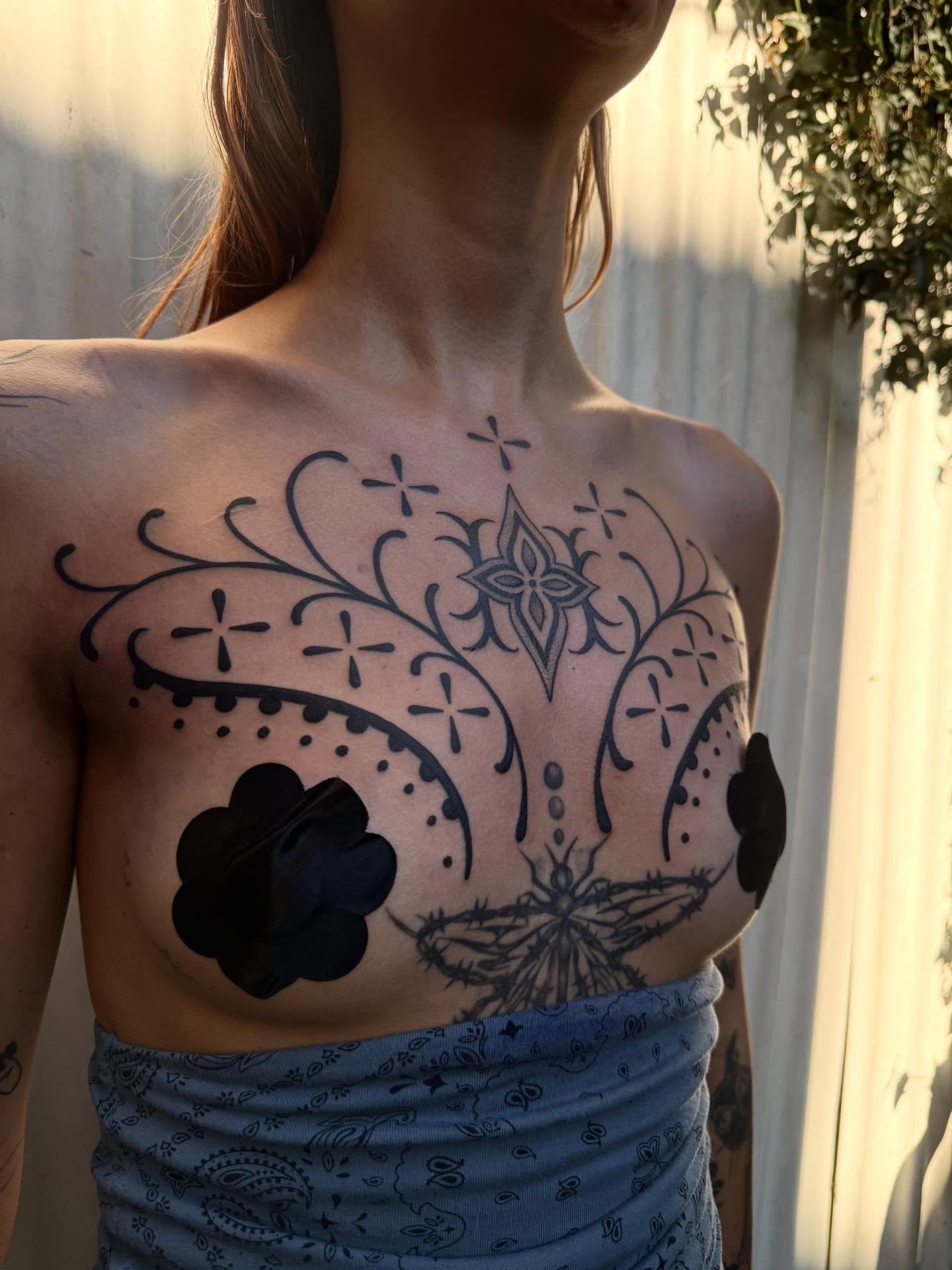 Sugar skull black and grey tattoo on the chest by Erin Shea