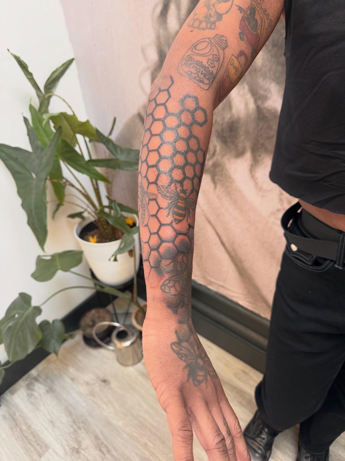 Hexagon pattern with bee geometric tattoo on the forearm by Sam Padilla