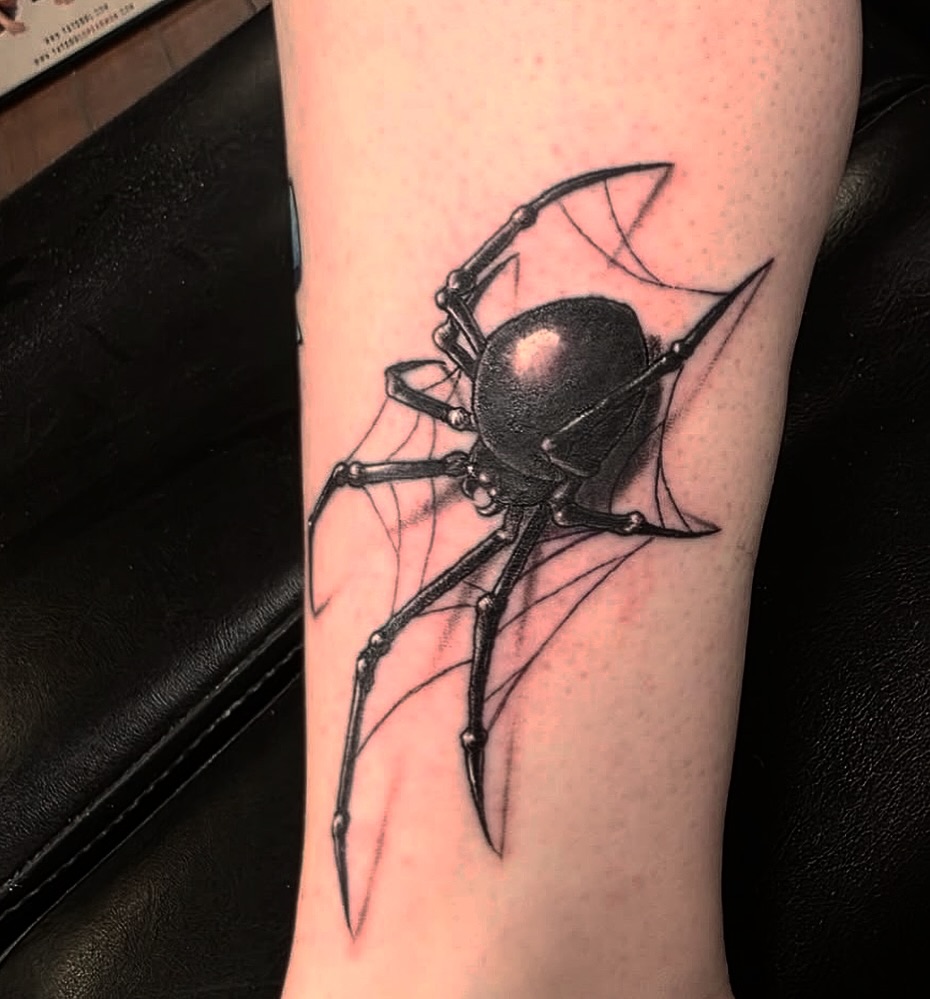 Black widow spider on web blackwork tattoo on the forearm by Jeff Frederick