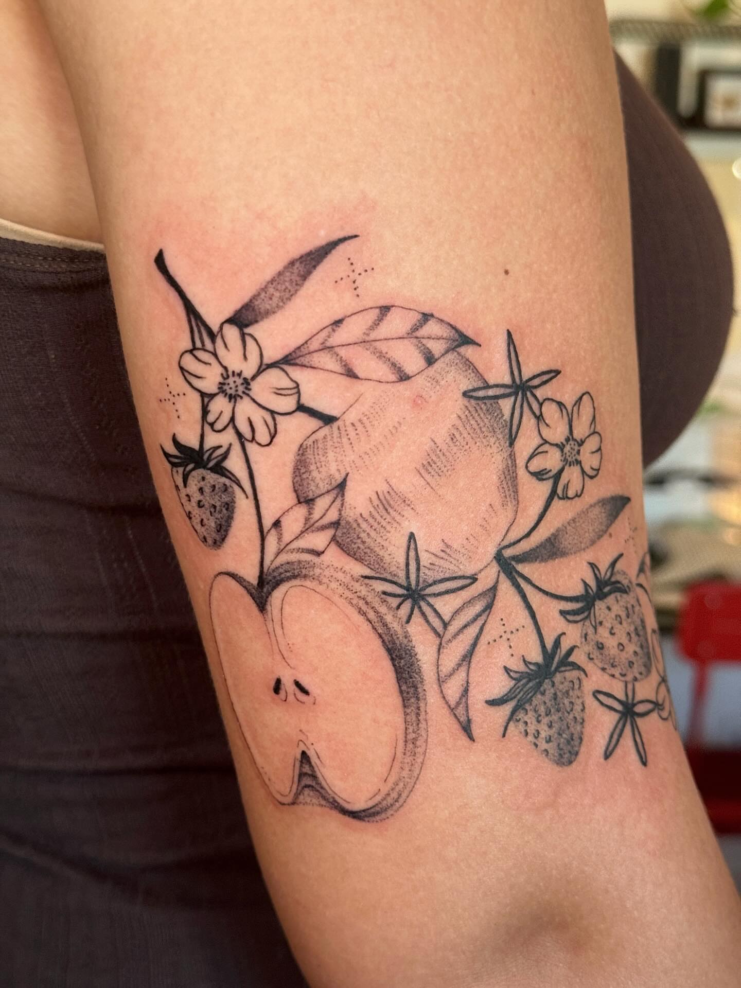 Fruit and floral arrangement black and grey tattoo on the forearm by tattoos by miss jackie o 🎱