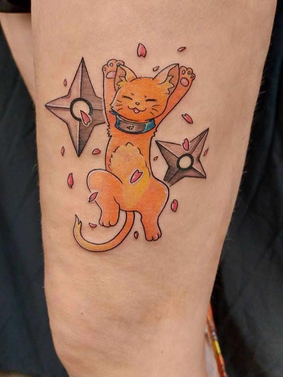 Cat anime tattoo on the forearm by Meghan Hounsell