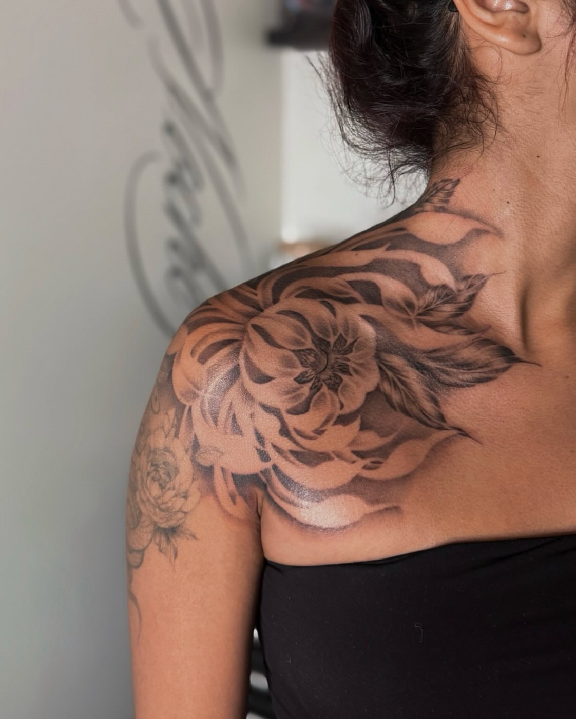 Floral black and grey tattoo on the shoulder by Jas Knight