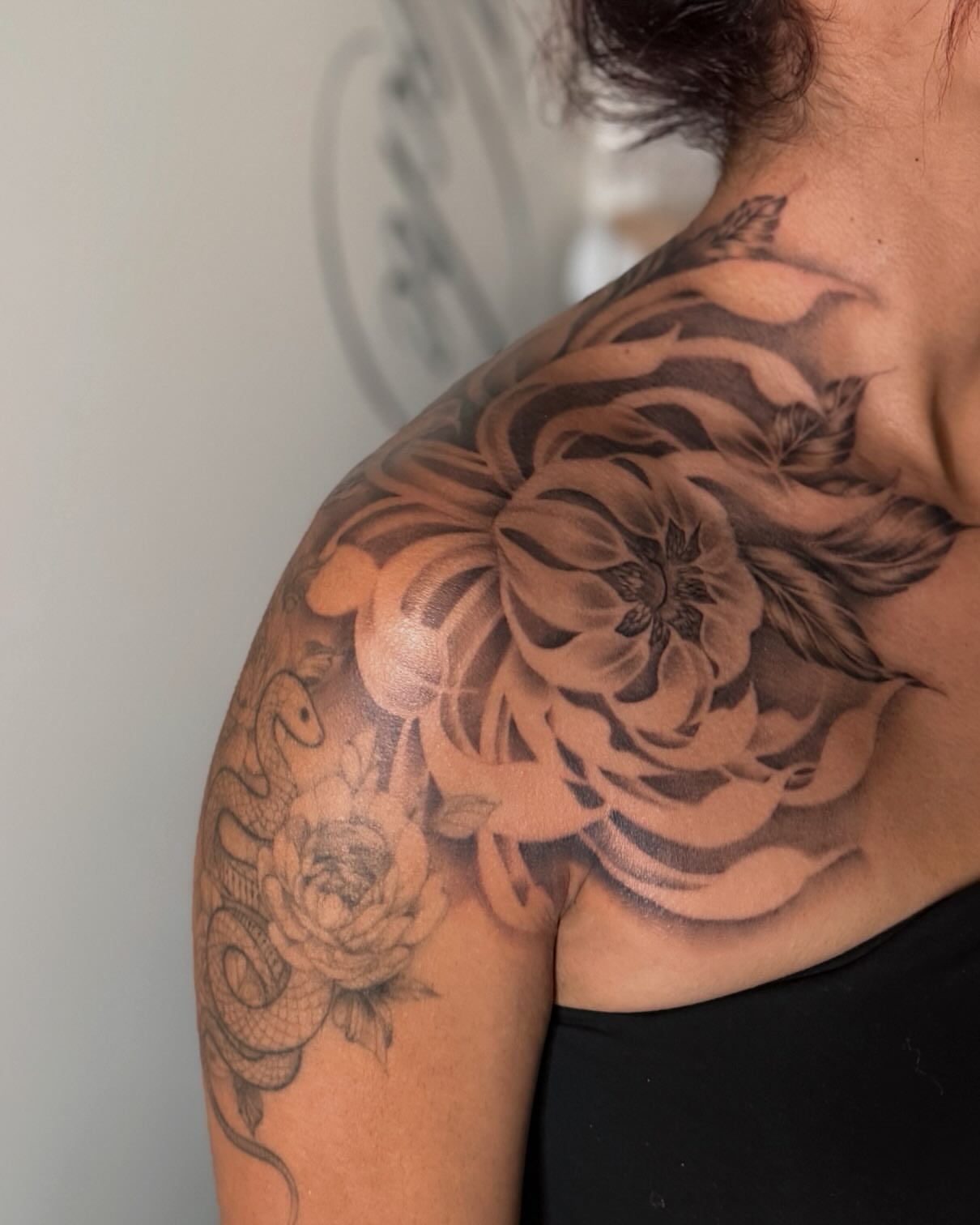 Peony and snake realism tattoo on the shoulder by Jas Knight
