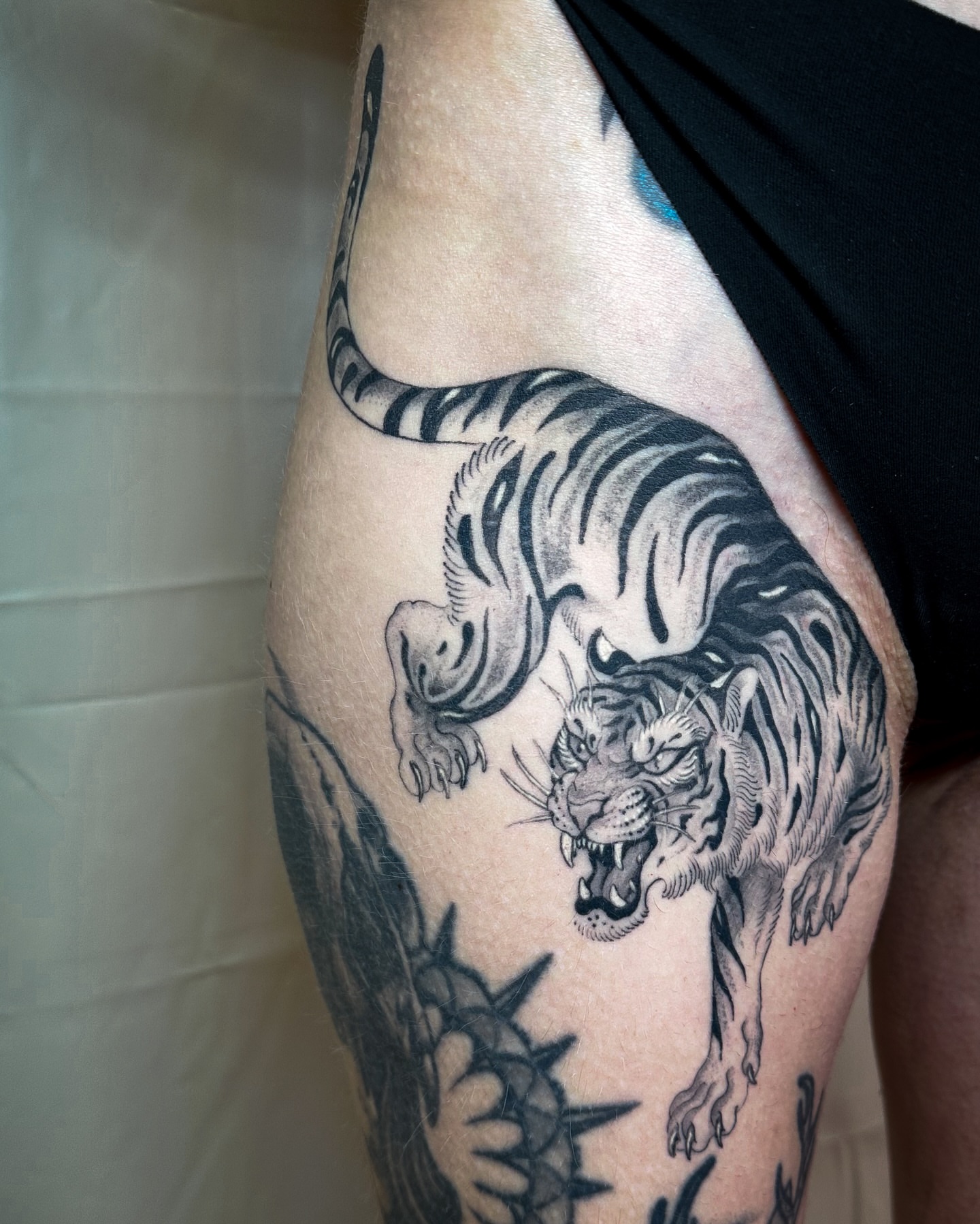 Tiger black and grey tattoo on the thigh by Colin Kenji Baker, San Jose, California