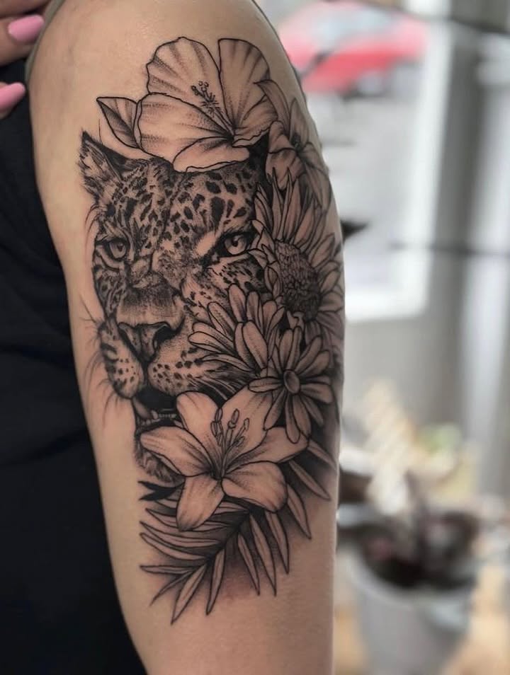 Leopard and flowers realism tattoo on the forearm by Allexis