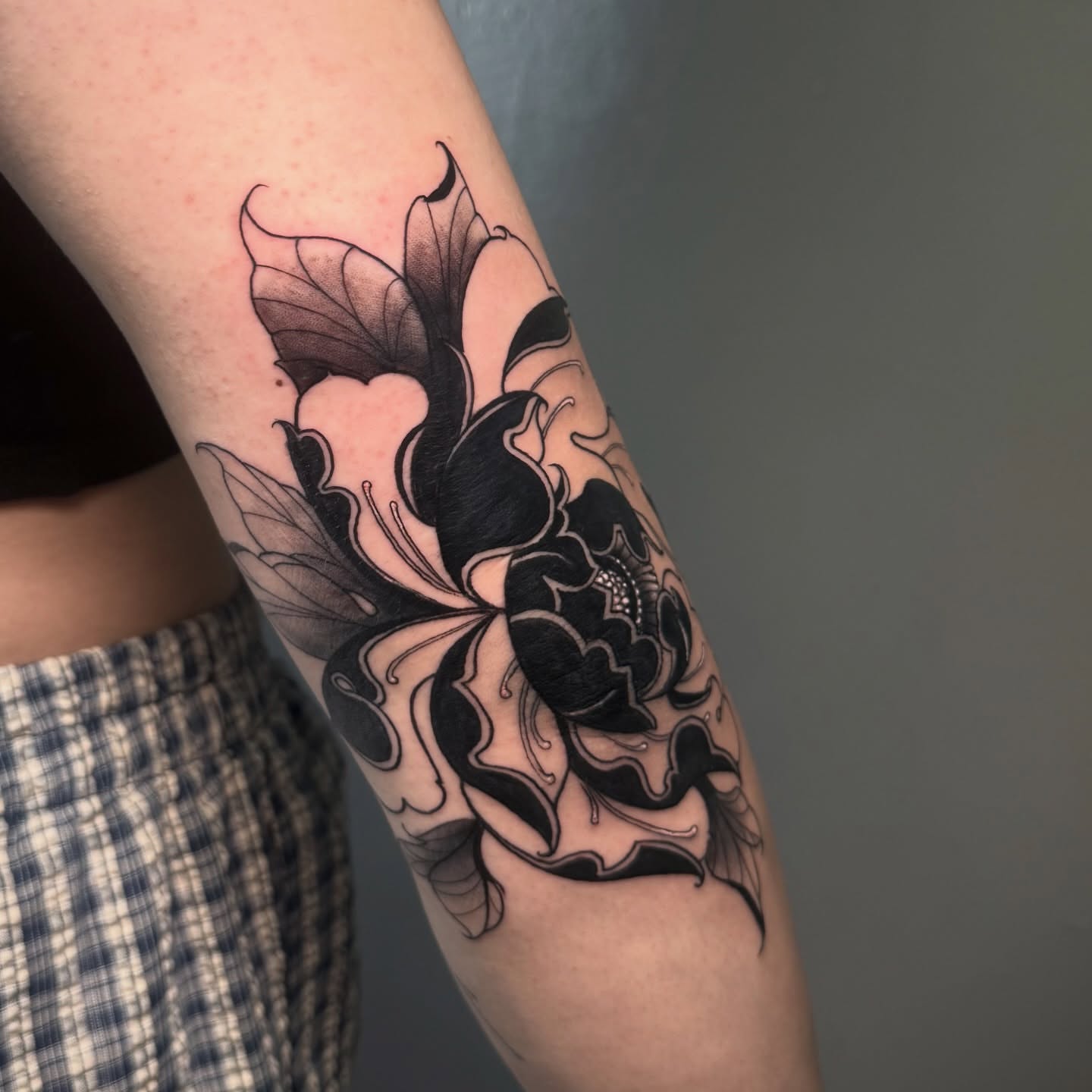 Lotus flower black and grey tattoo on the forearm by π·ππ