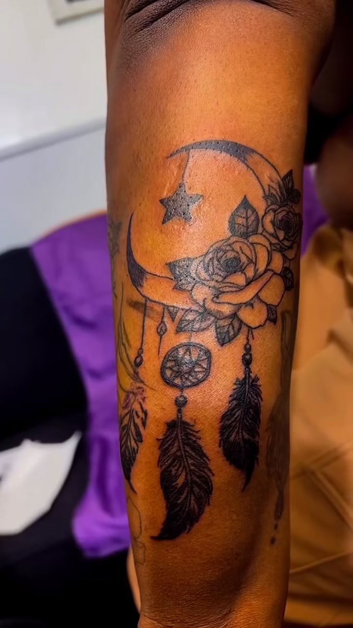 Dreamcatcher with moon and flowers fine line tattoo by Syneca Wilson, Acton, Massachusetts